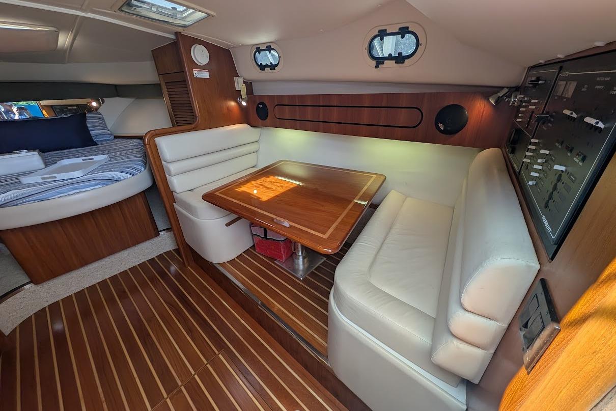 2000 Pursuit 3400 Express cabin interior with wood accents and seating area.