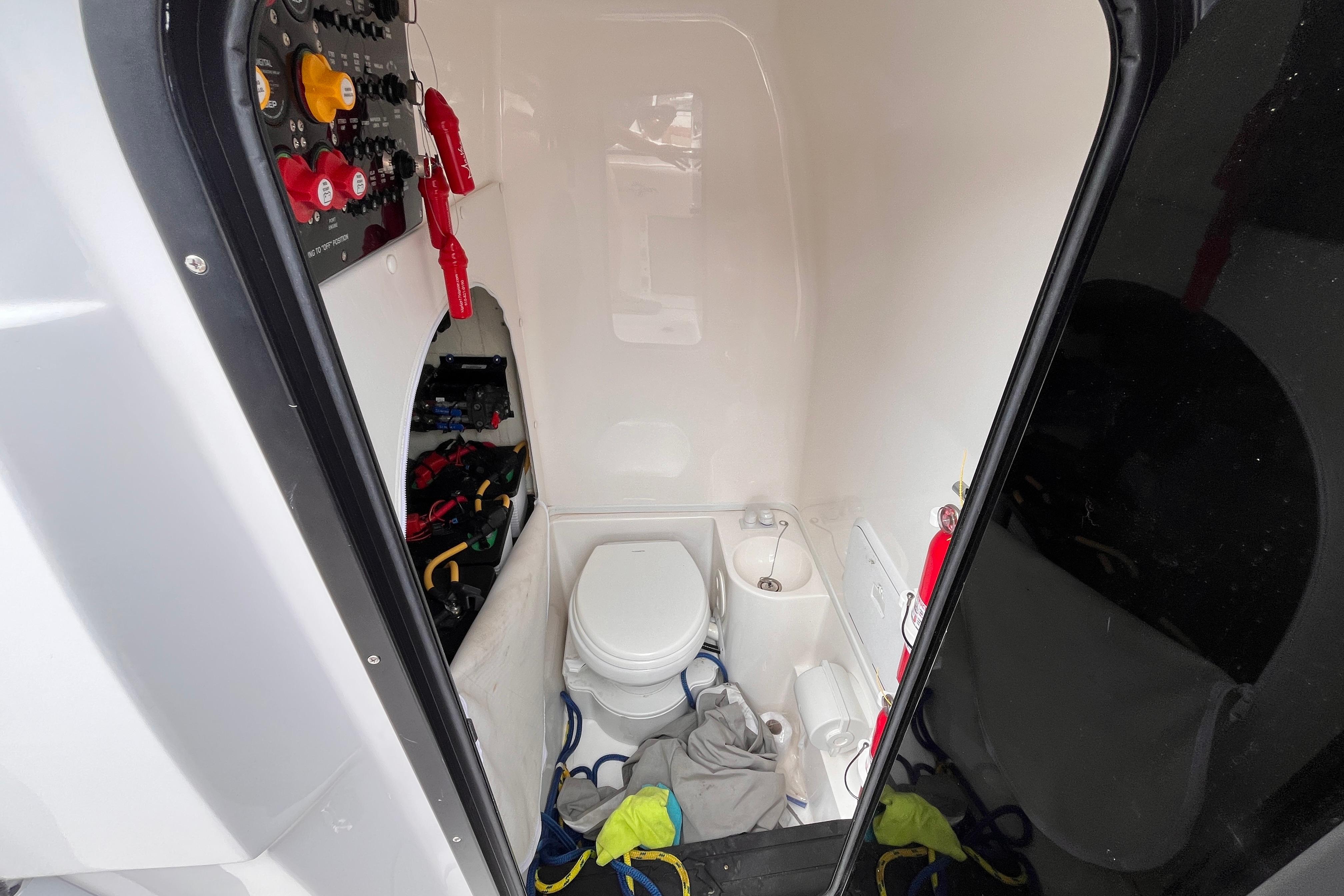 Interior of 2024 Fountain 34 Tournament Edition boat with toilet and control panel.