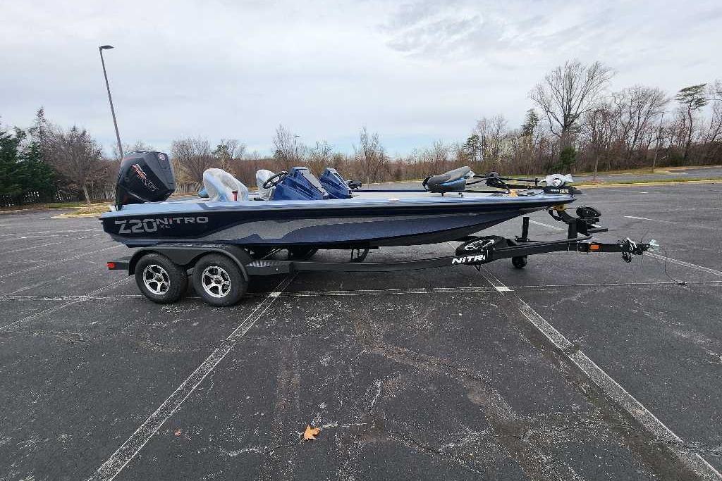 2026 Nitro Z20 XL boat on trailer in parking lot, overcast sky.