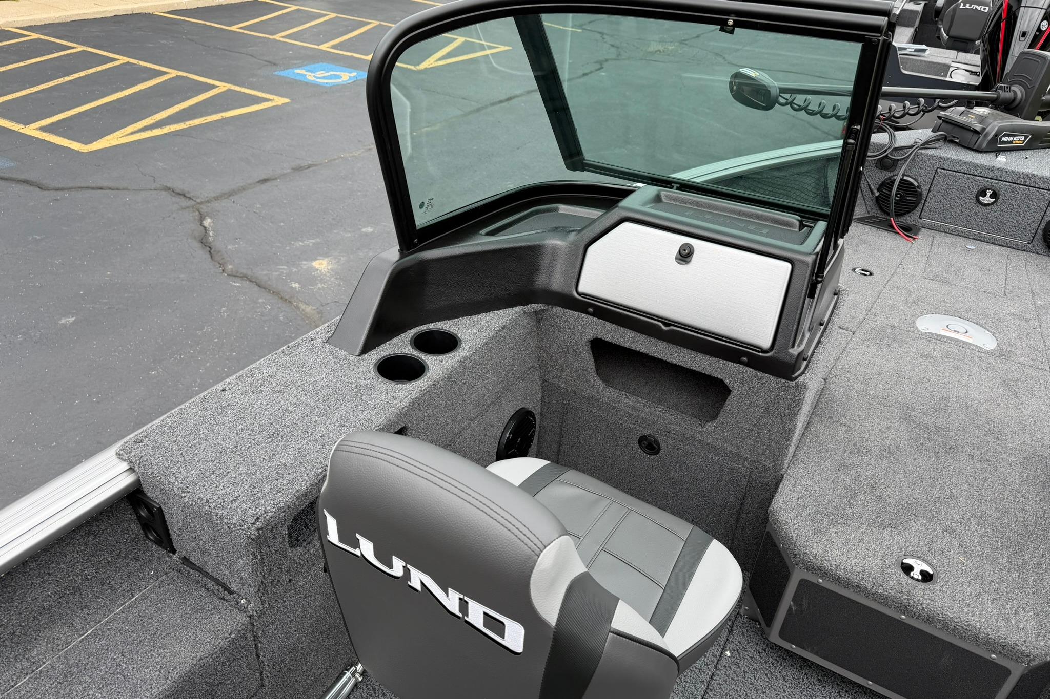 2027 Lund 1875 Impact XS Sport boat interior with seating and storage compartments.