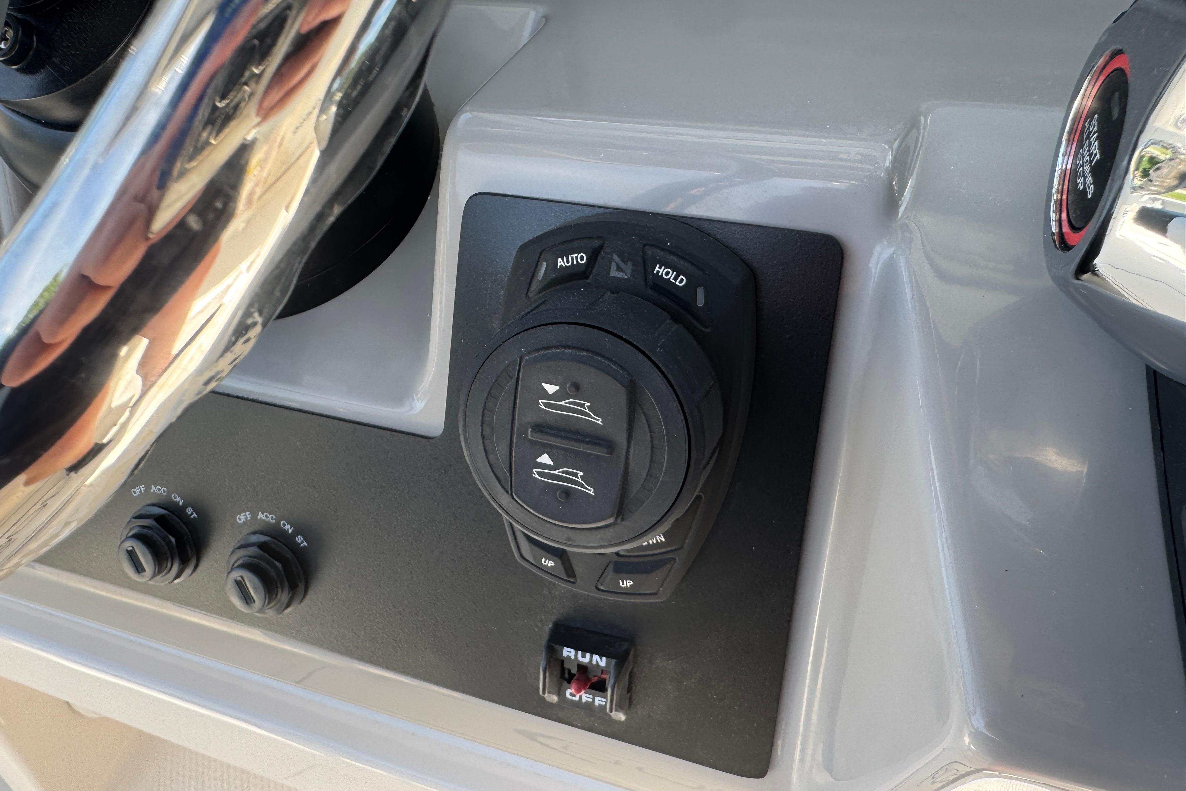 2026 Robalo R250 Center Console boat control panel with steering wheel and switches.