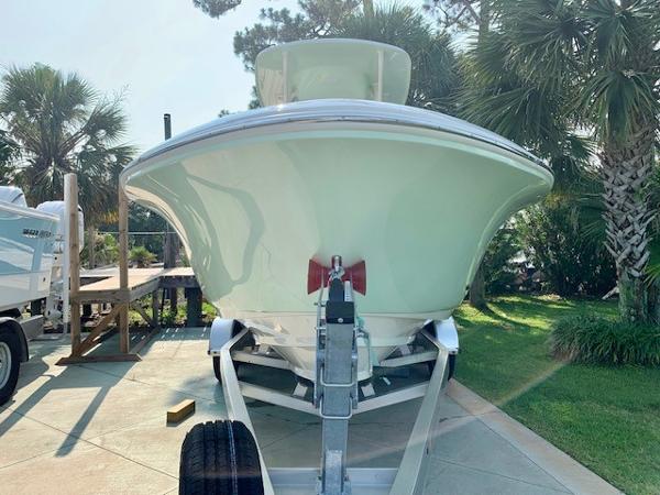2025 Pioneer 222 Islander boat on trailer, surrounded by palm trees.