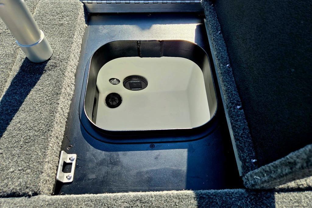 Storage compartment in 2026 Skeeter ZXE20 boat, featuring a sleek, carpeted interior design.