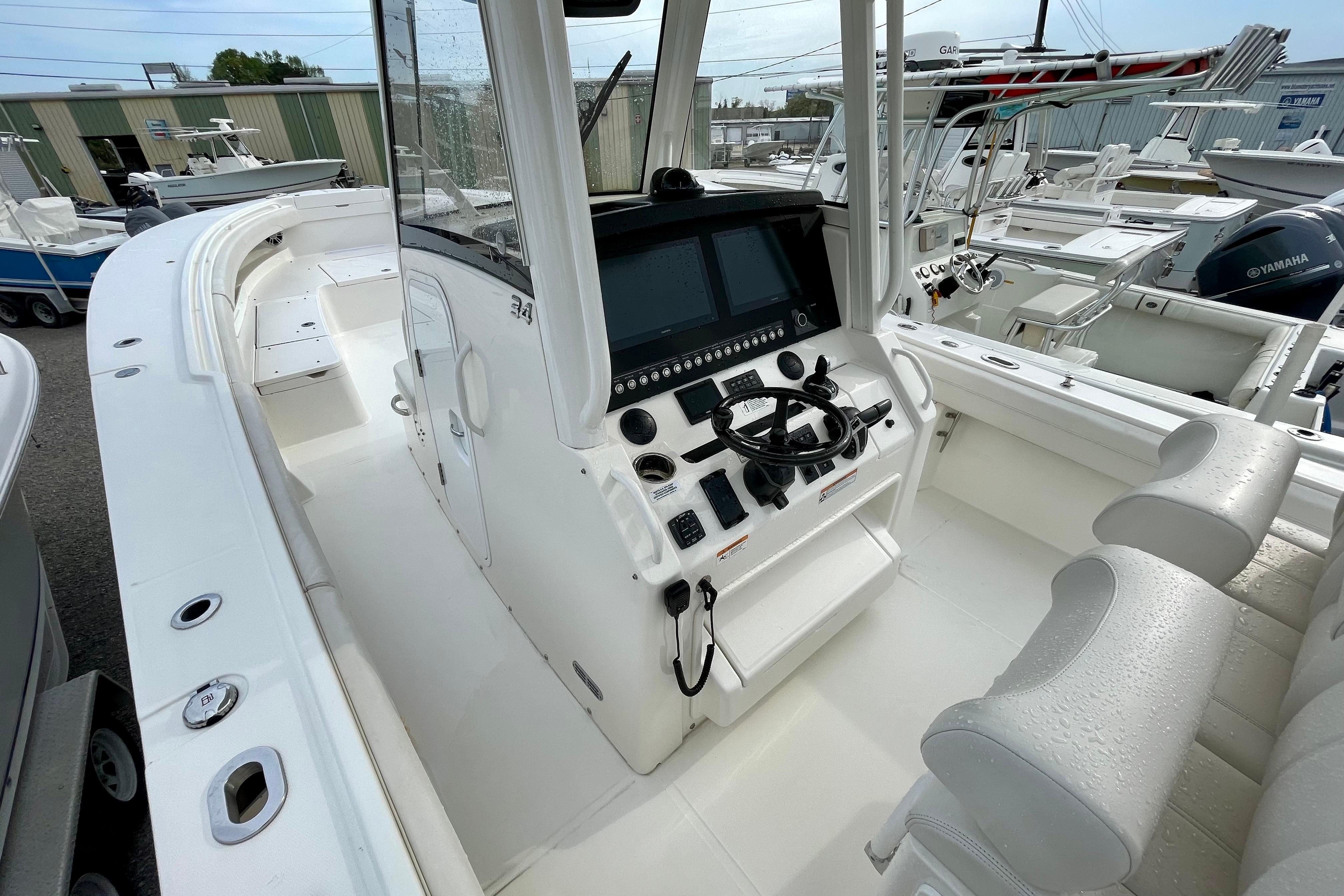 2023 Regulator 34 boat cockpit with modern controls and seating in a marina setting.