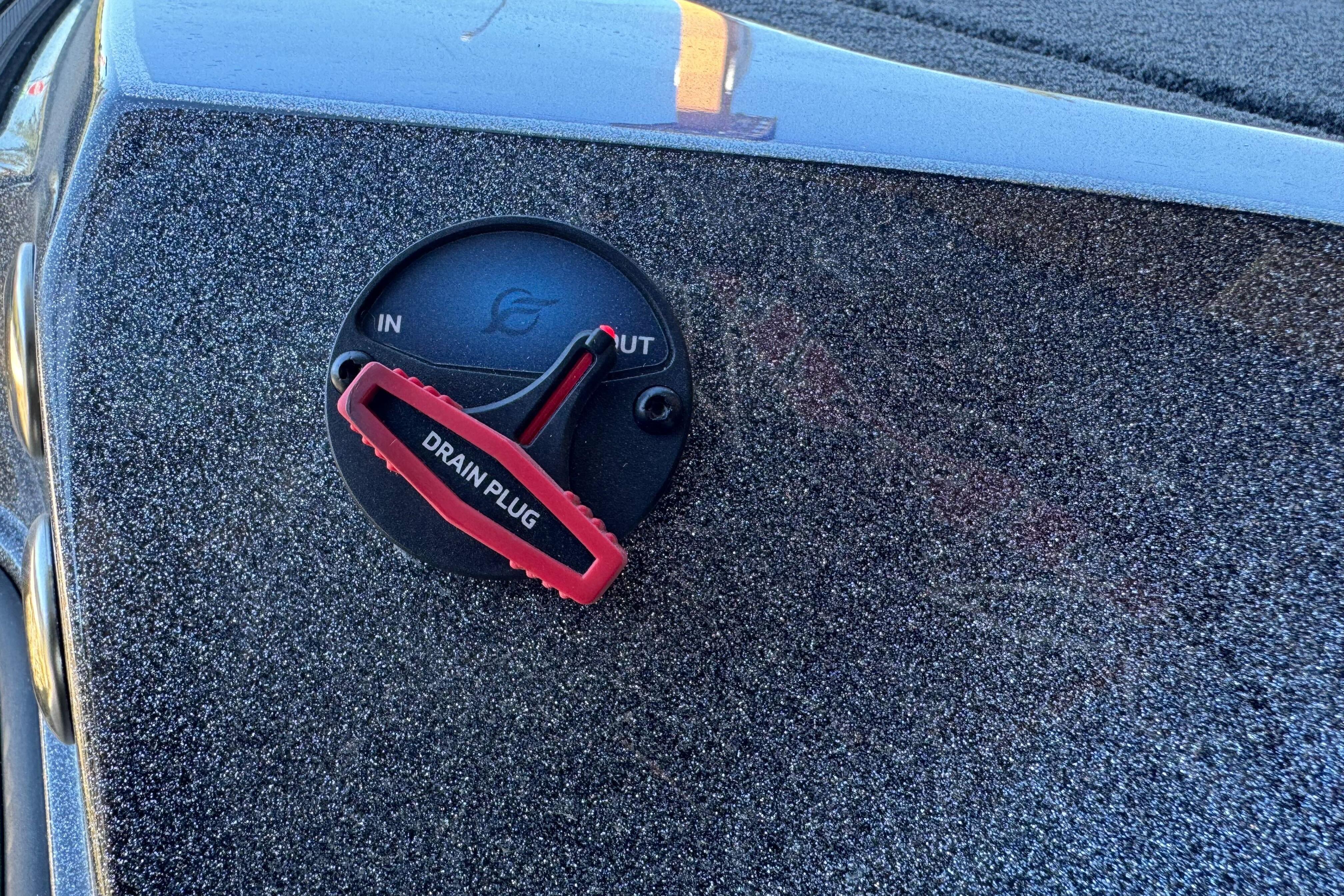 Drain plug on 2026 Triton 21XP Patriot boat, featuring textured surface.