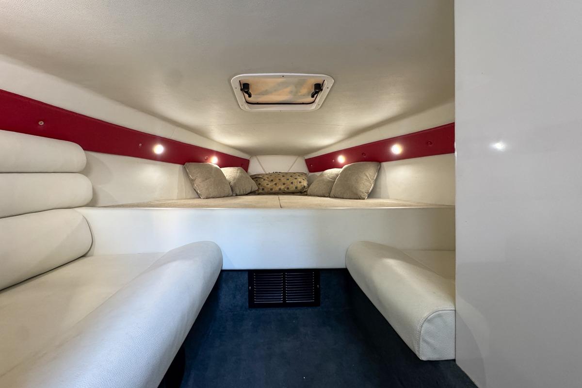 2022 Velocity 290sc boat cabin interior with cozy seating and ambient lighting.