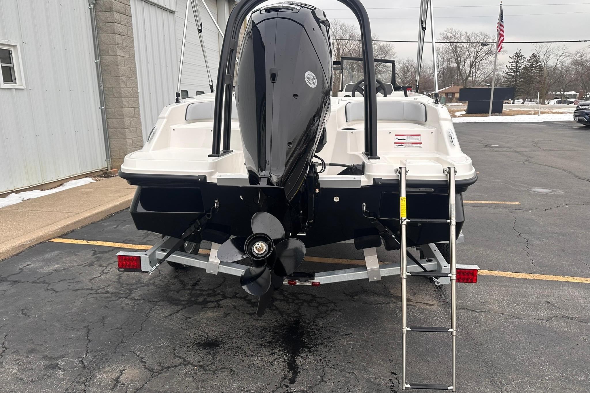 2026 Bayliner M17 boat rear view with outboard motor and ladder.
