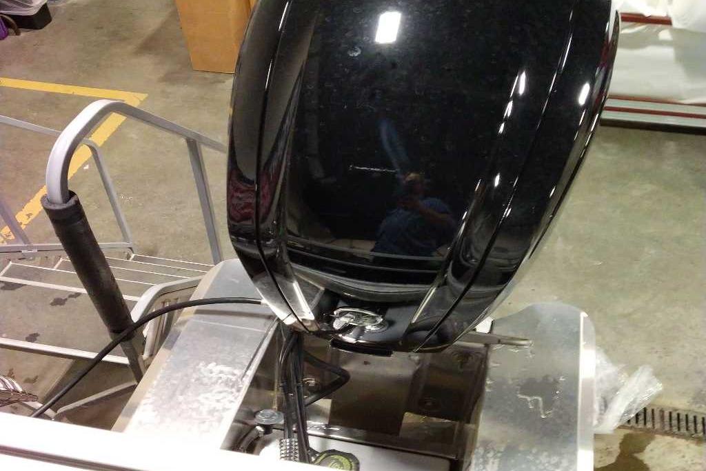 2026 Sun Tracker Bass Buggy 18 DLX boat motor in a garage setting.