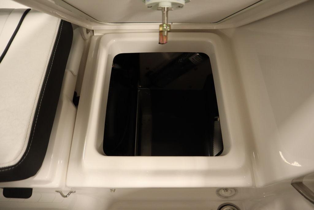 2026 Yamaha Boats 255 FSH Sport E storage compartment, open view.