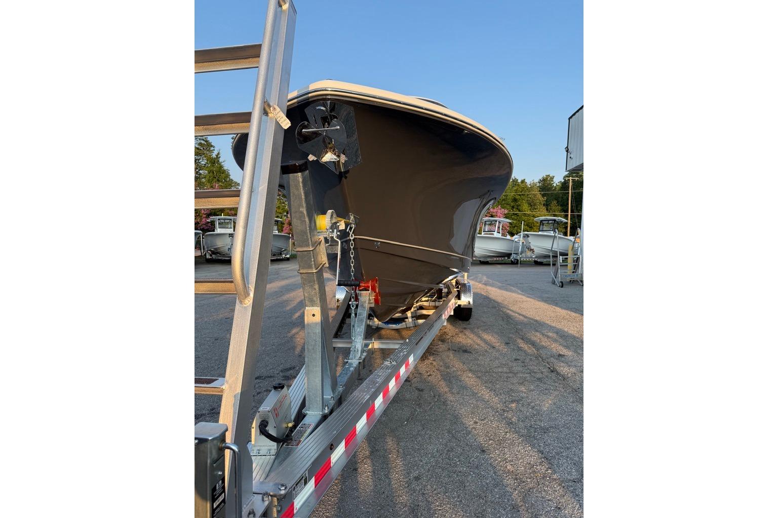 2026 Sea Hunt Gamefish 27 Coffin Box boat on trailer, parked outdoors.