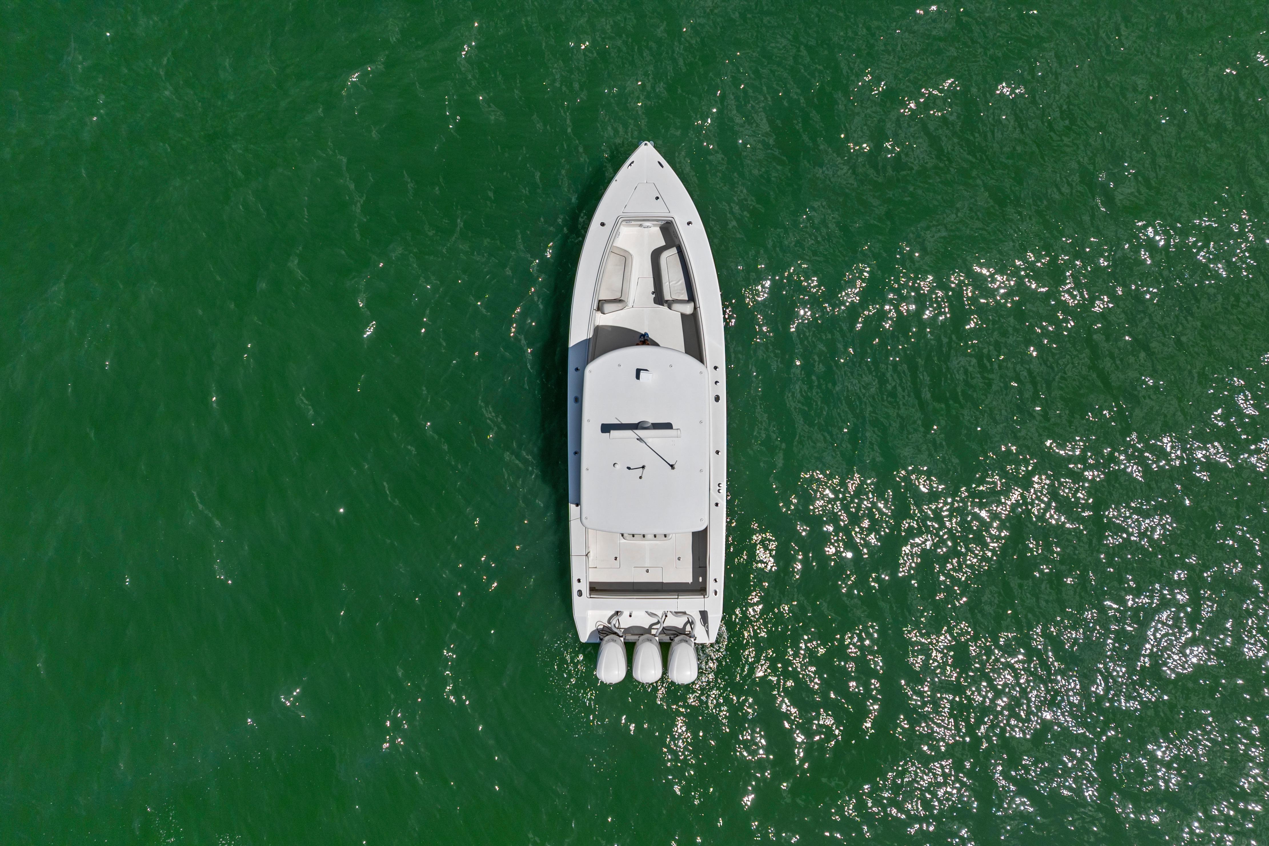 Aerial view of 2015 Jupiter 34 HFS boat on vibrant green water.