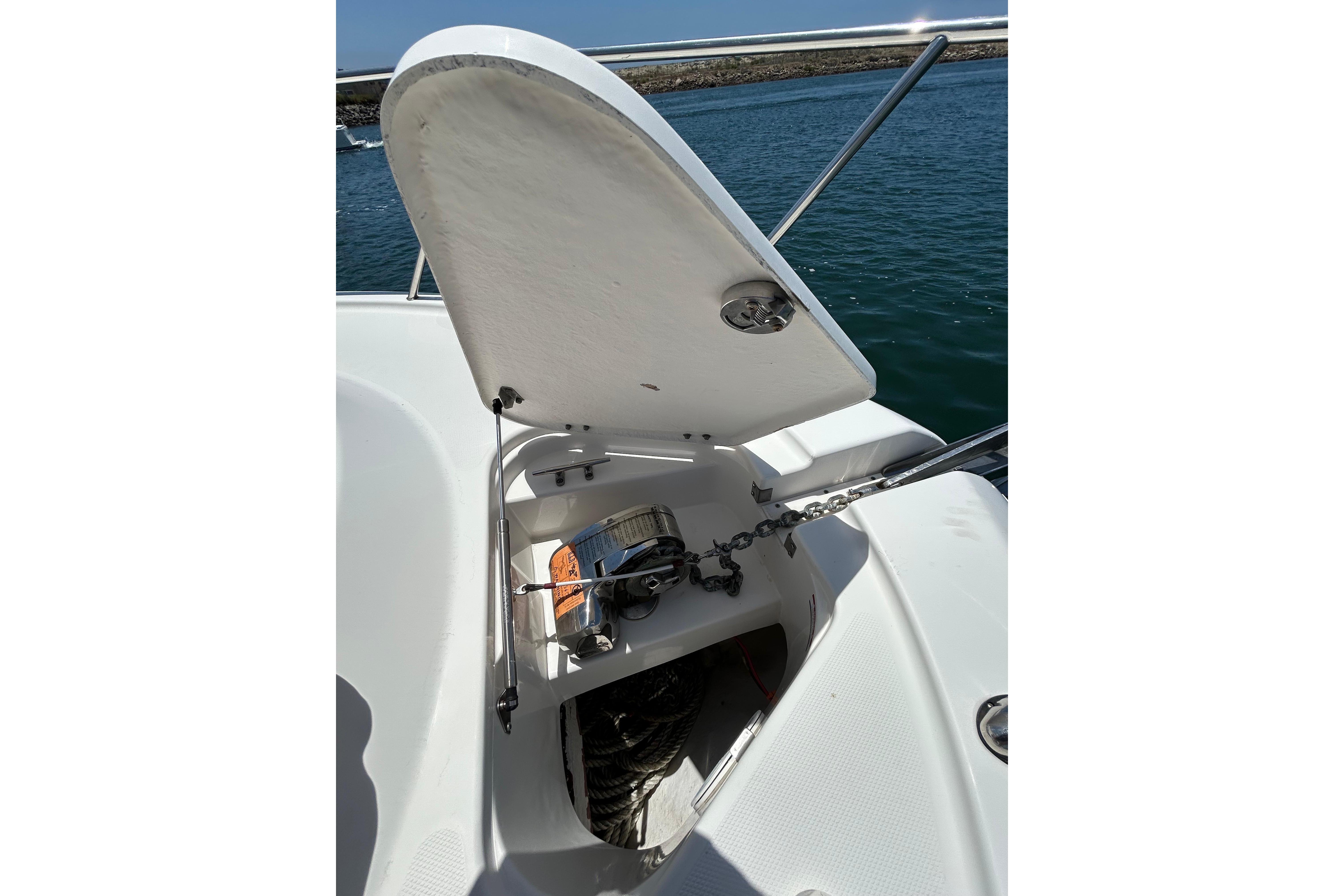 2007 Robalo R305 Walkaround anchor locker with open hatch and visible chain mechanism.