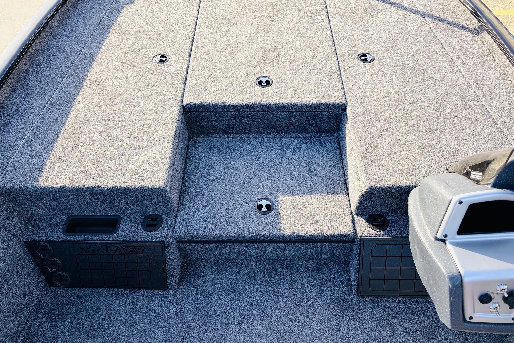 2025 Tracker Savage 215 boat interior with carpeted deck and storage compartments.