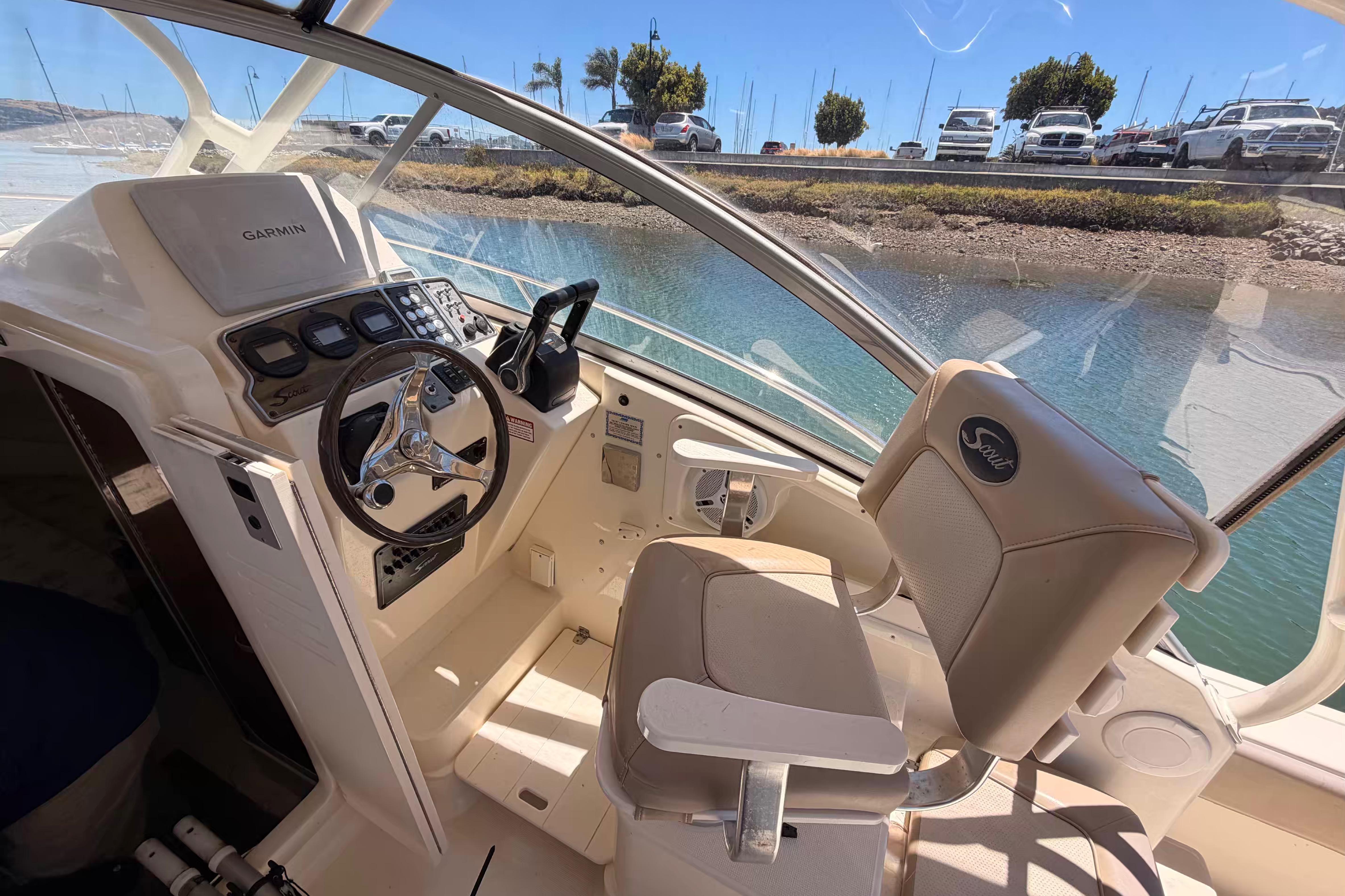 Interior of 2007 Scout 262 Abaco boat with steering wheel and Garmin navigation system.
