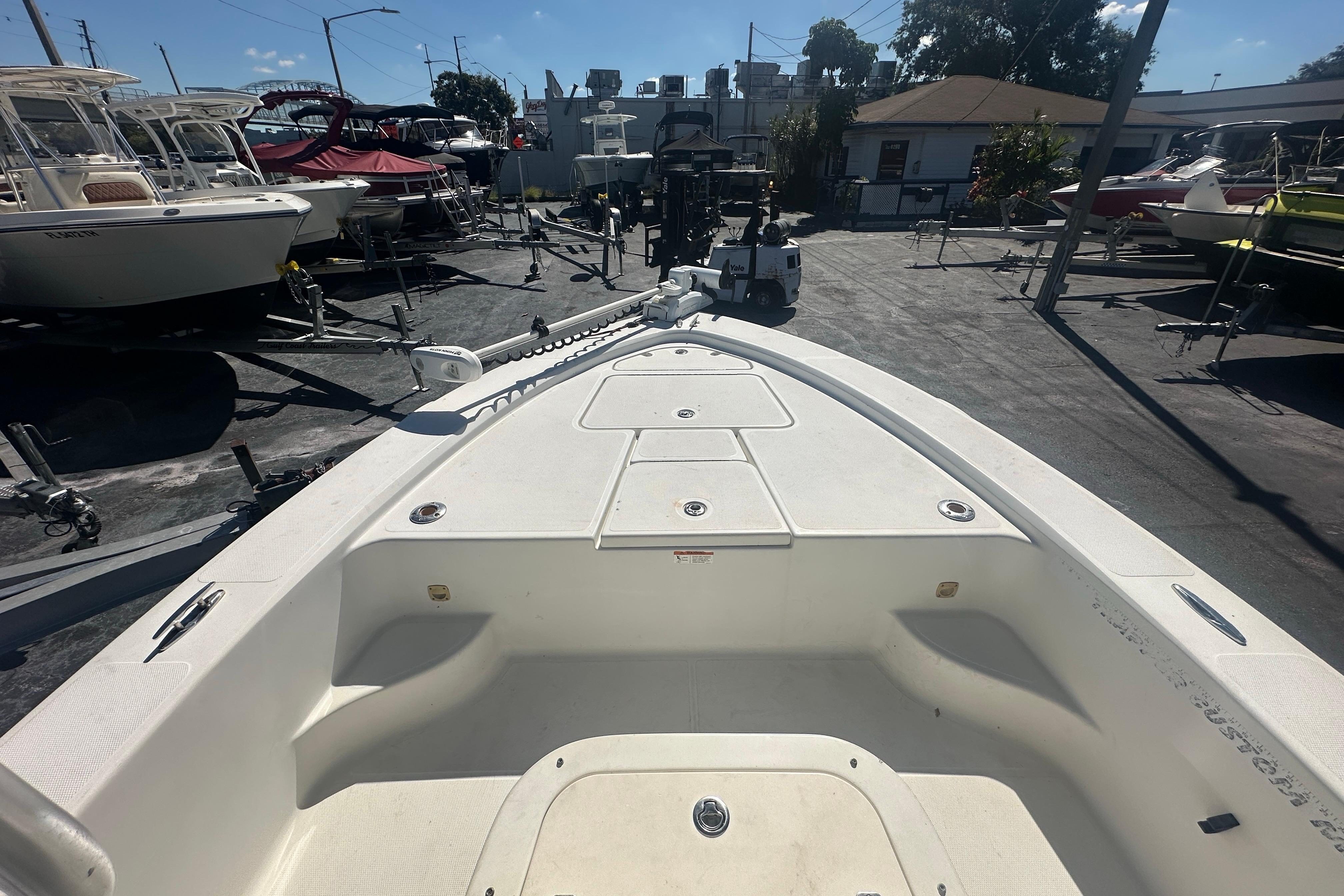 2003 Hydra-Sports 19 Bay Bolt boat, white deck, parked in a marina with other boats.