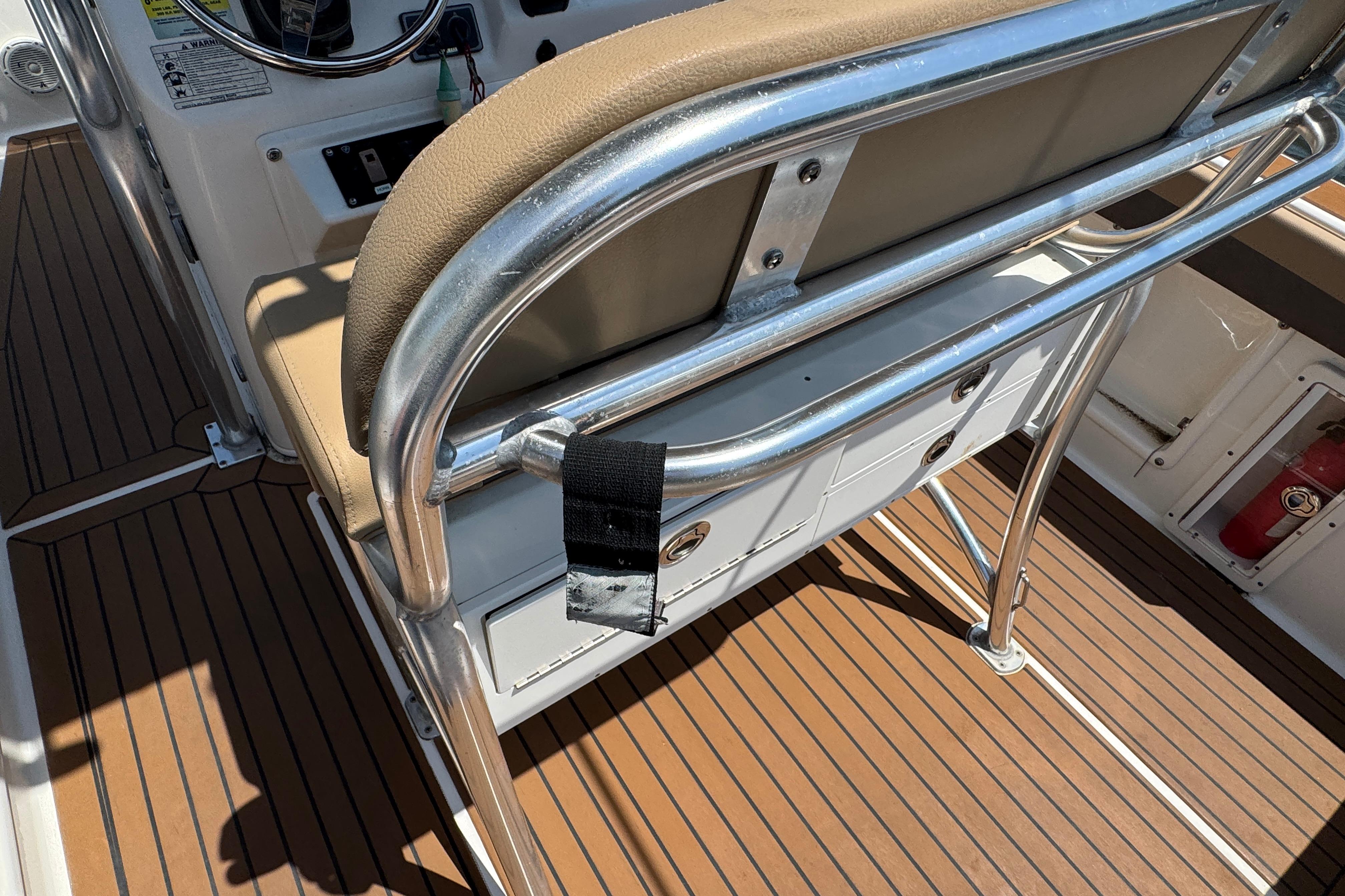 2014 Century 2301 Center Console boat interior with tan seating and wood-style flooring.