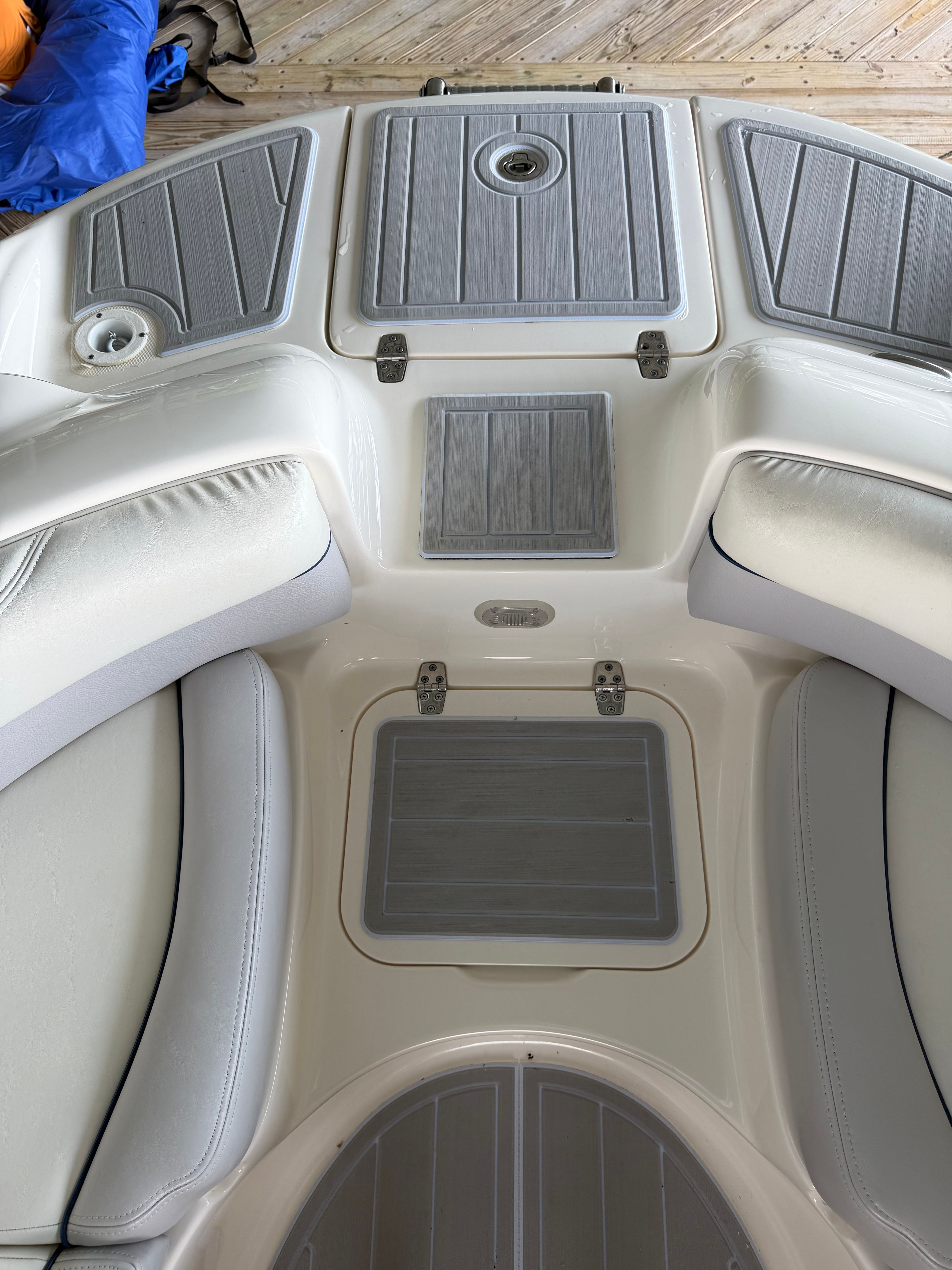 Interior of a 2010 Bryant 255 boat with gray upholstery.