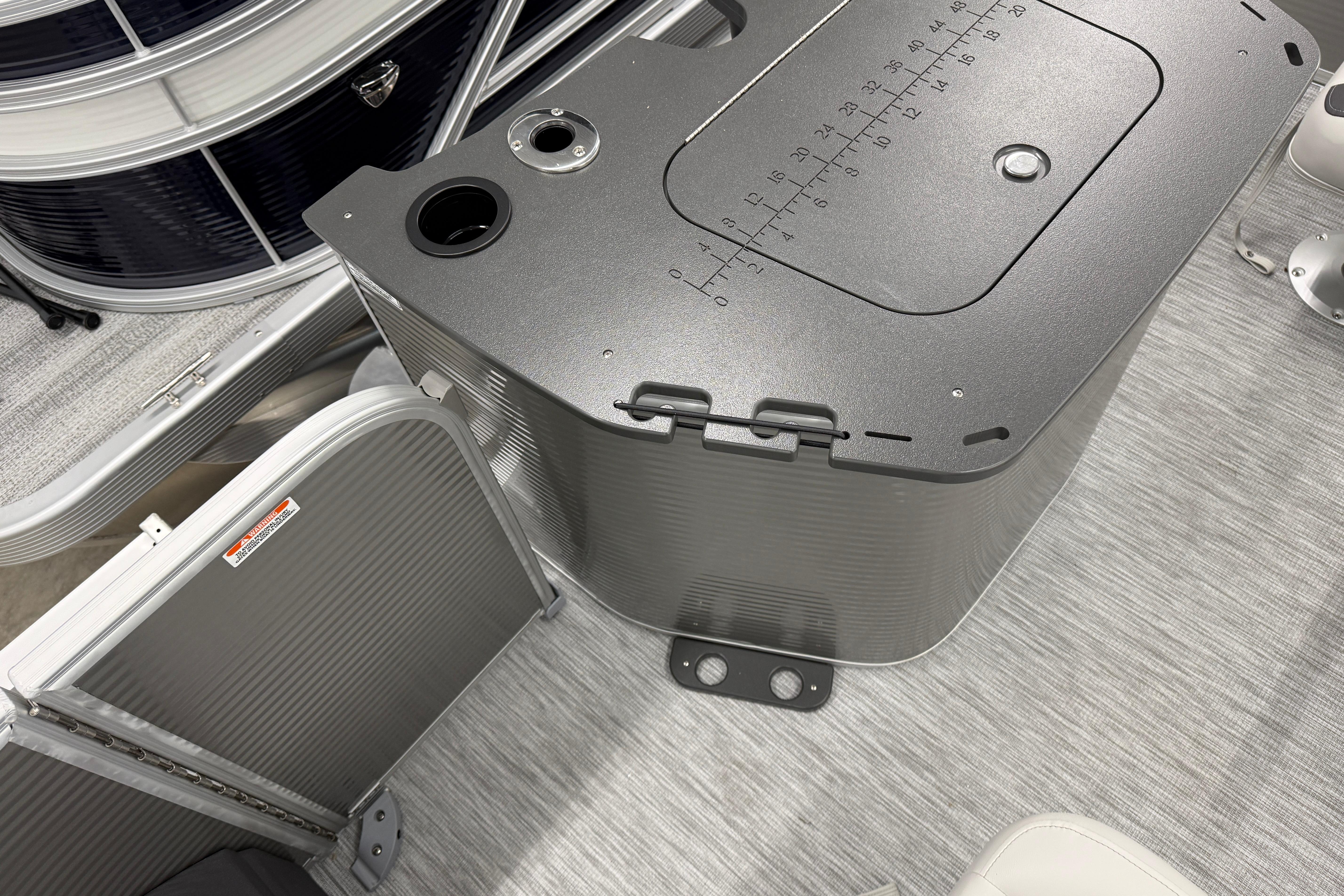 2026 Bennington 20 SF boat interior with storage compartment and measuring scale.