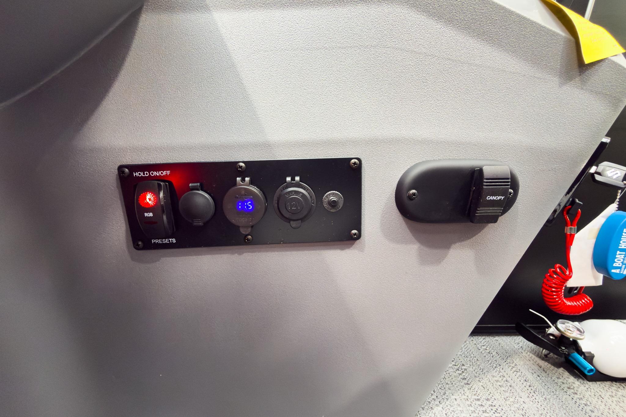 Control panel of 2026 Godfrey Sweetwater 22' Tritoon with RGB lighting and canopy switch.