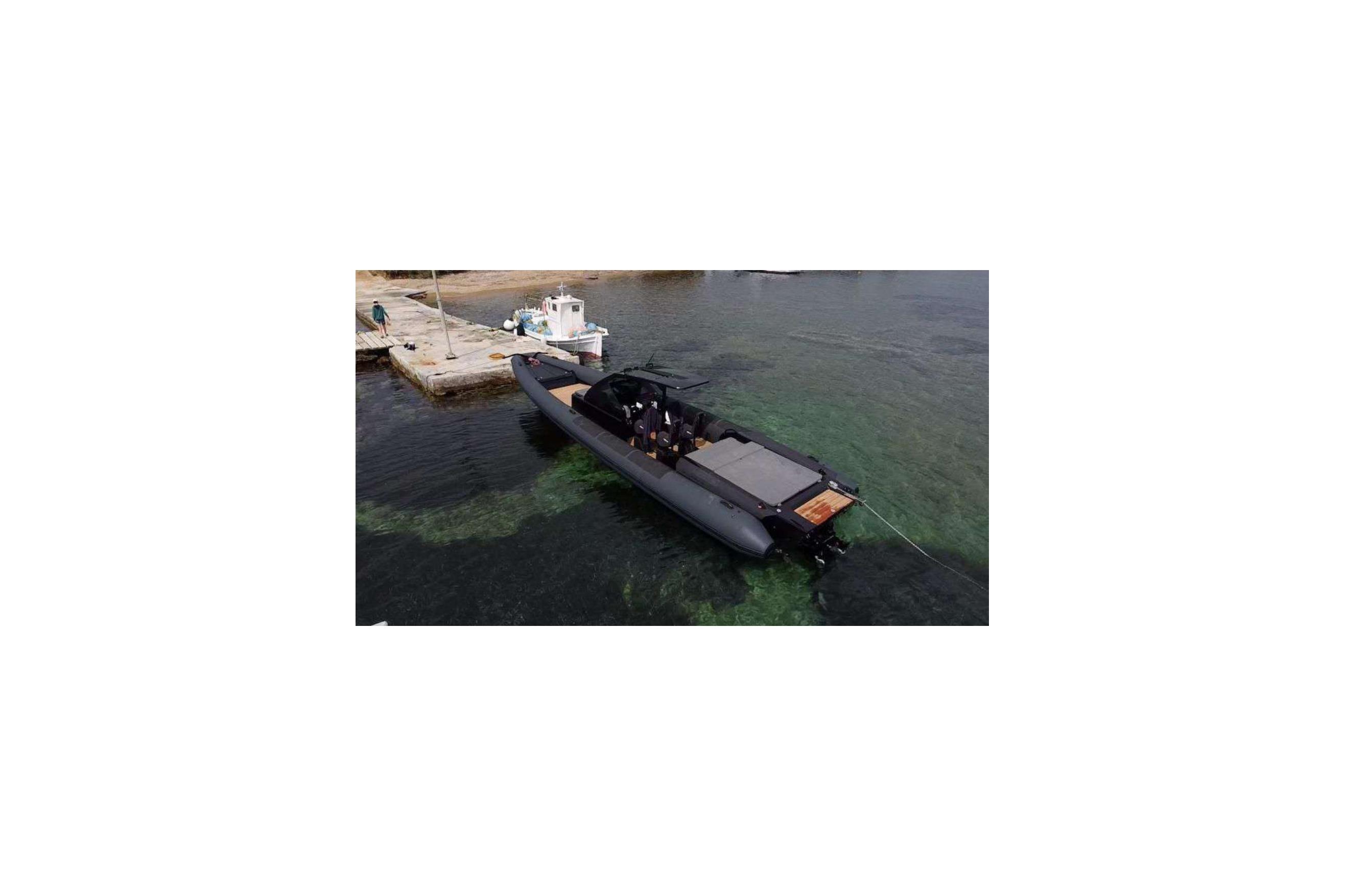 2023 Goldfish 38 Sport boat docked on clear water near a pier.