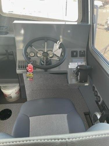 Interior of 2025 Spartan 2600 Olympia vehicle, featuring steering wheel and control panel.