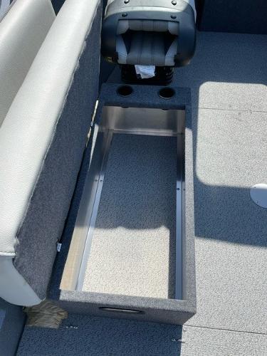 2025 Spartan 185 Astoria boat interior with storage compartment and seating.
