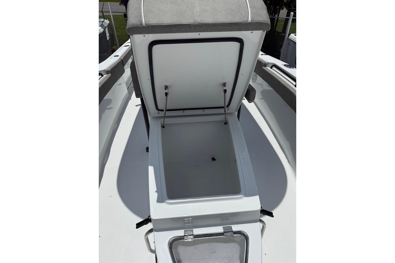 Open coffin box on 2026 Sea Hunt Gamefish 27 boat, showcasing spacious storage.