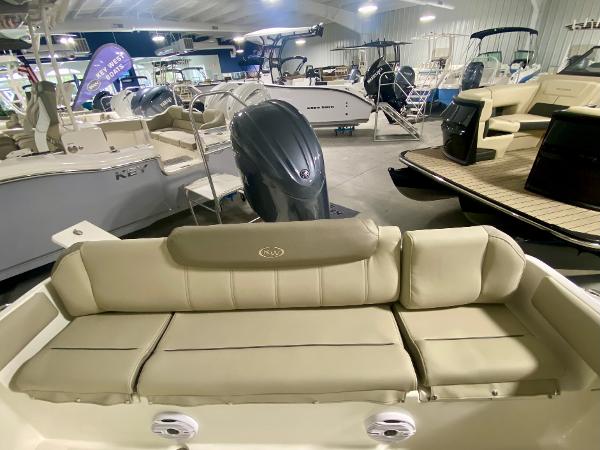 2024 Key West 219 FS boat interior with cushioned seating in showroom.