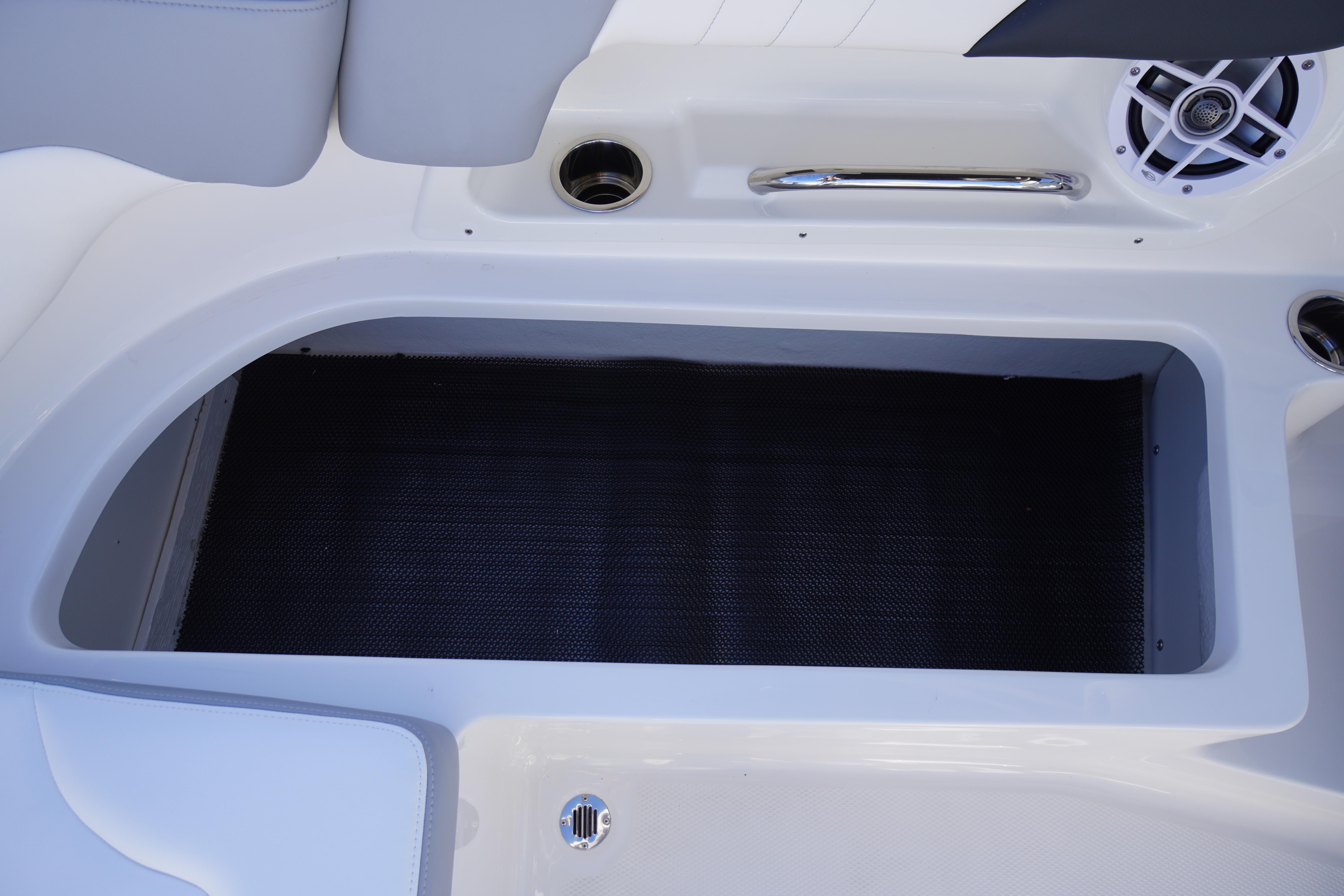 2026 Chaparral 23 SSi boat storage compartment with speaker and handle.