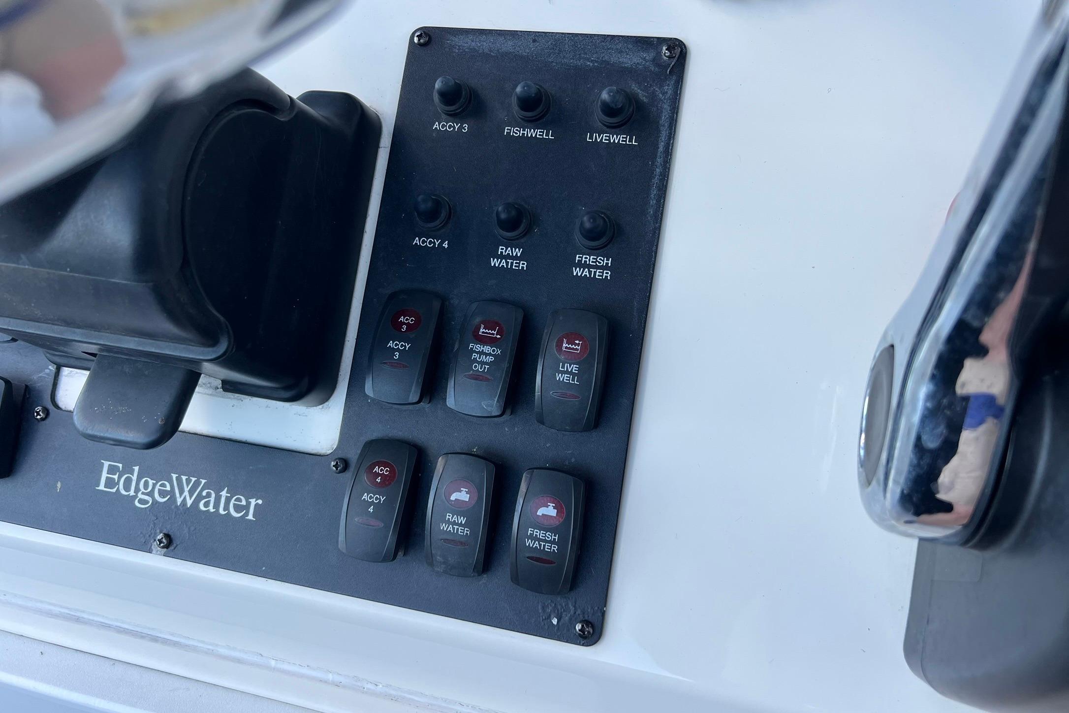 Control panel of a 2006 Edgewater 245CC boat with various switches and labels.
