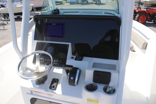 2023 Sea Pro 239 Center Console boat dashboard with steering wheel and controls.