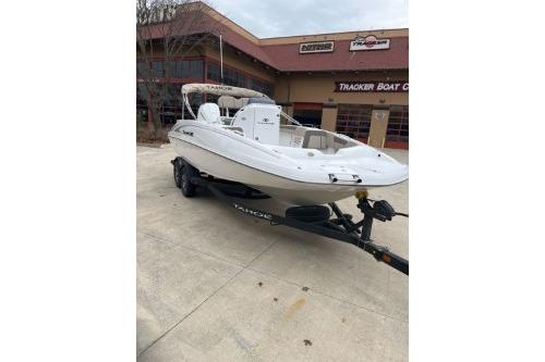 2025 Tahoe 2150 CC boat on trailer outside dealership building.