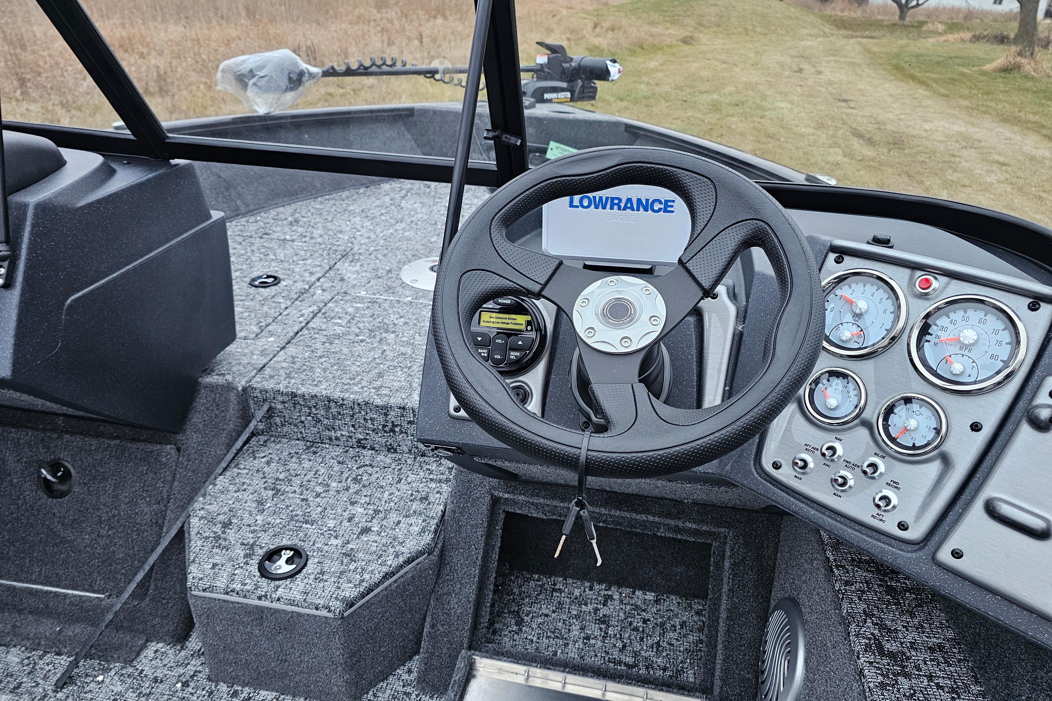 2026 Tracker Pro Guide V-175 WT boat dashboard with steering wheel and gauges.