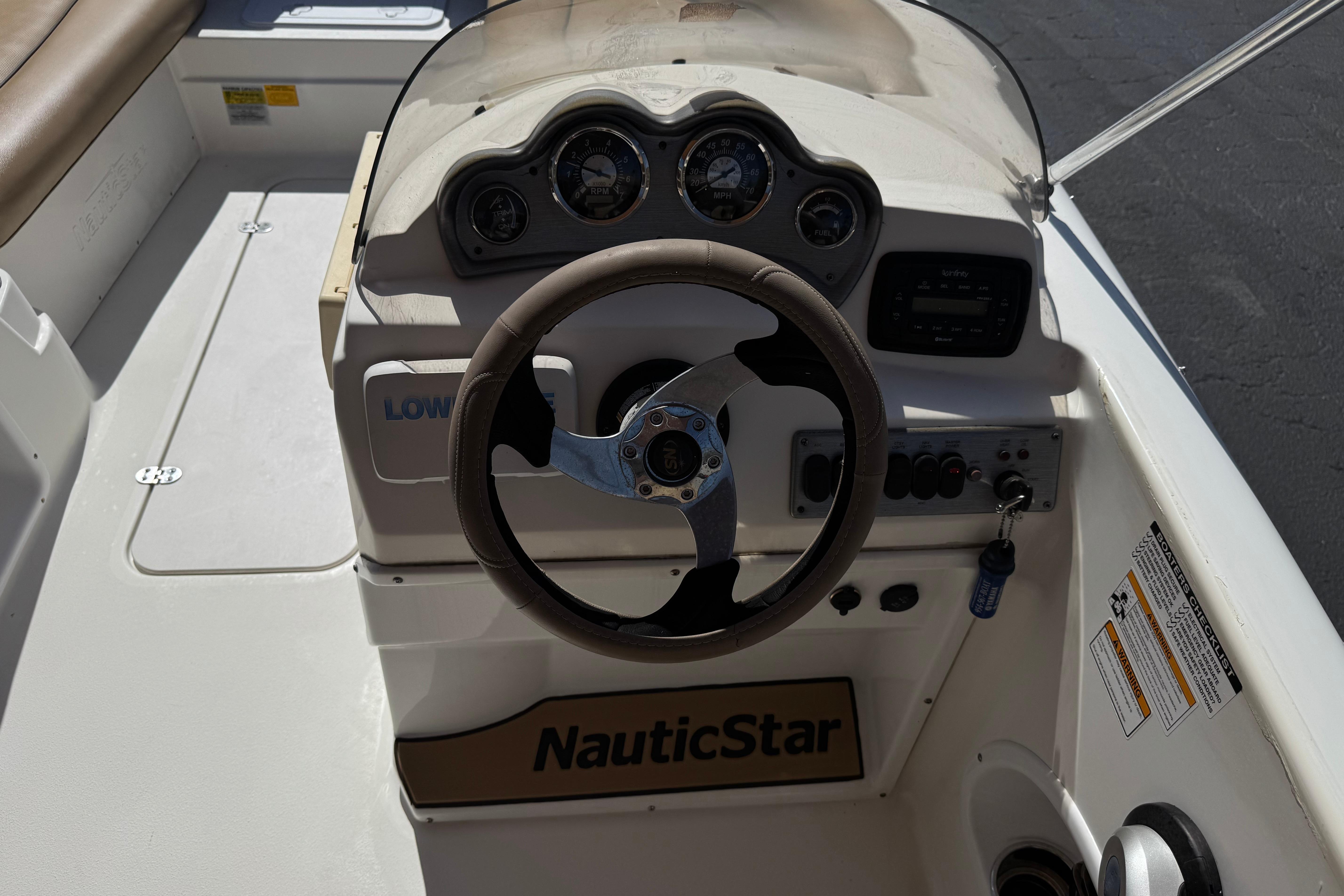 2020 NauticStar 203 SC boat dashboard with steering wheel and gauges.