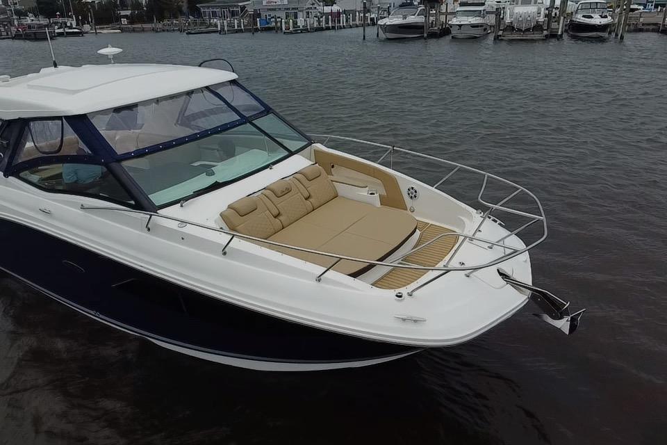 2021 Sea Ray Sundancer 320 Outboard yacht docked in marina, featuring spacious deck seating.