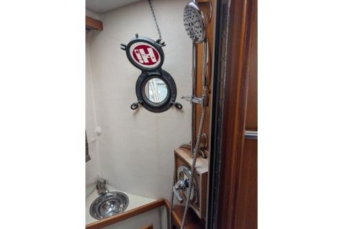 Head with shower and porthole window.