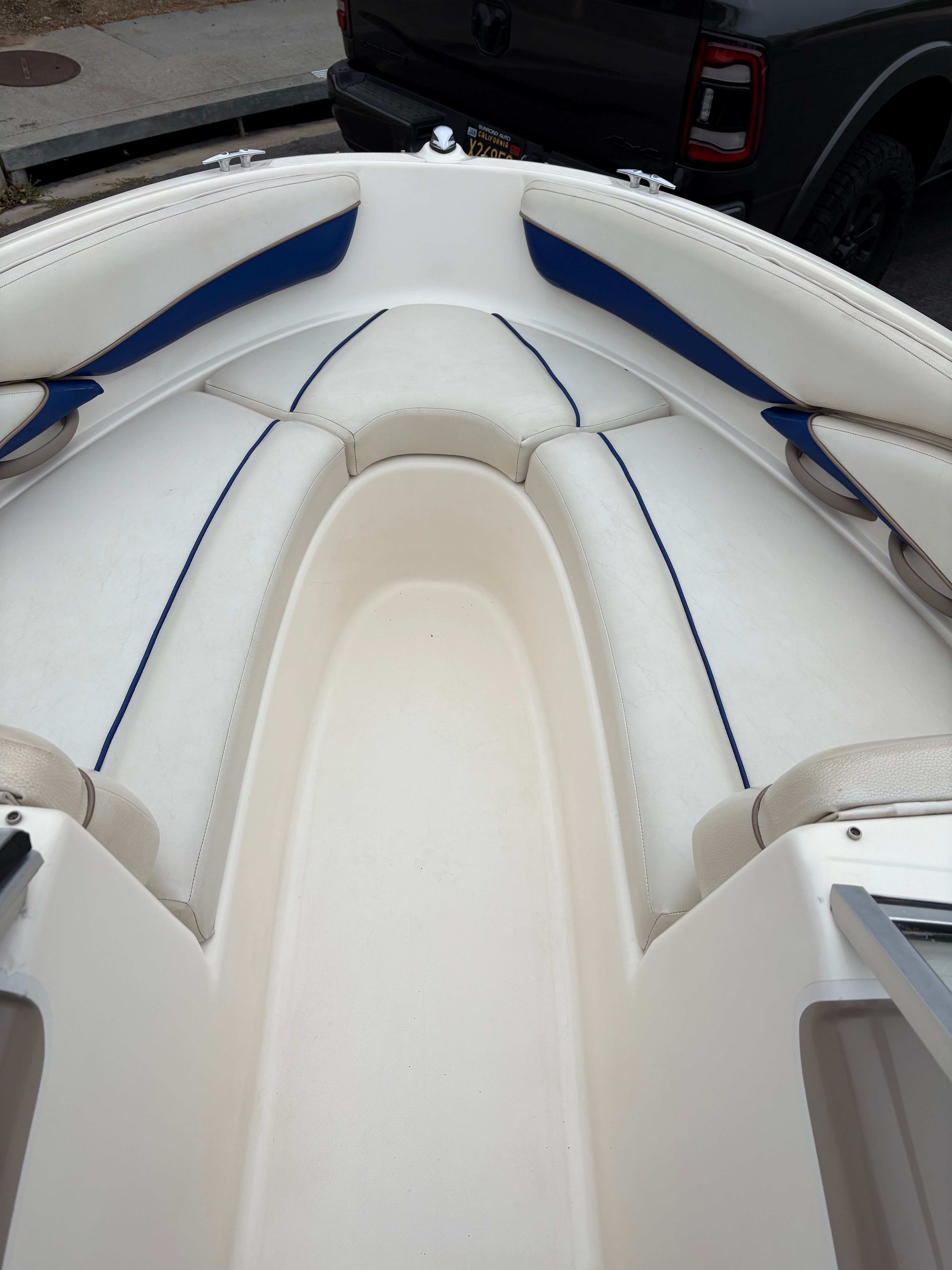 2003 Bayliner CAPRI 205 boat interior with white and blue seating.