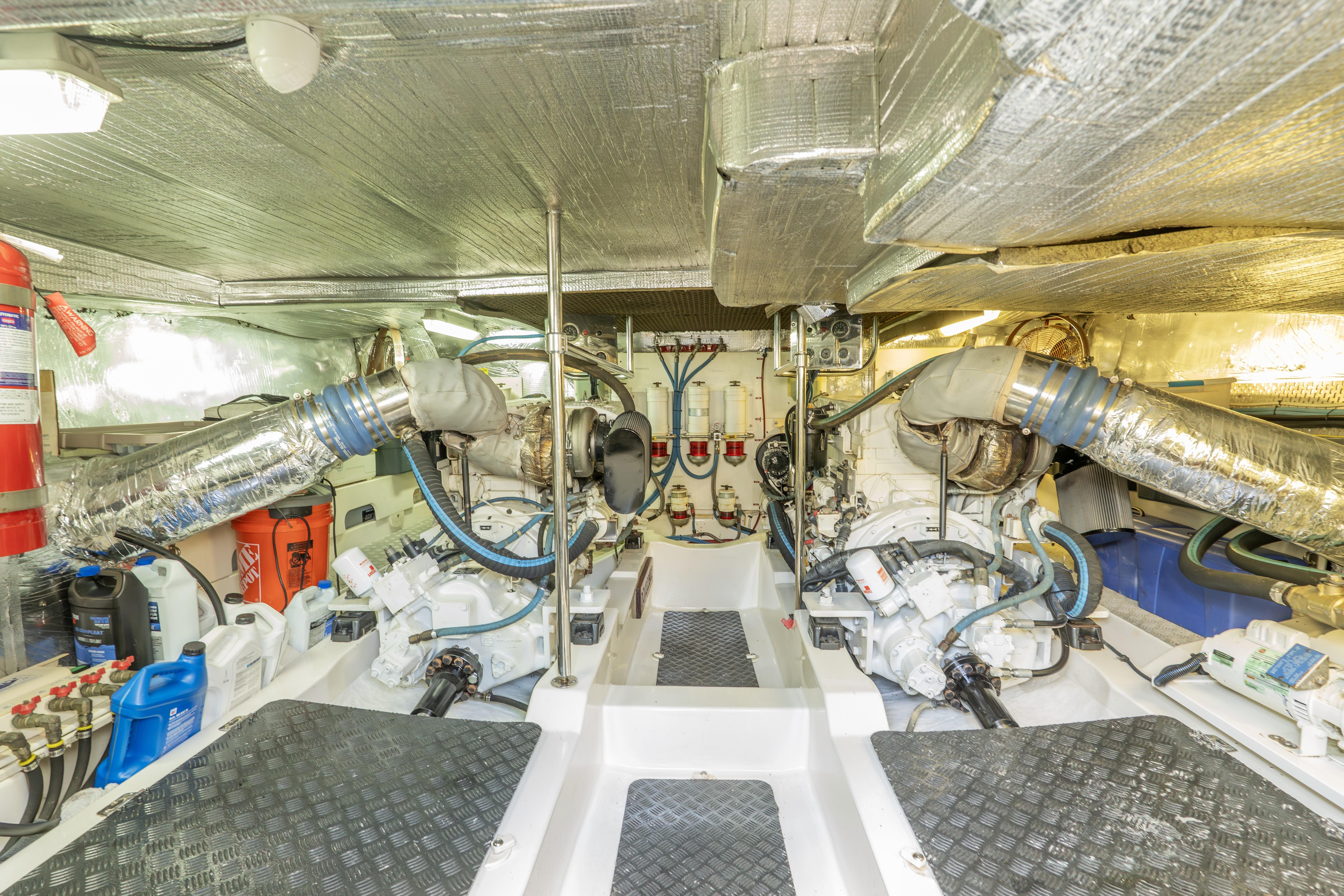 Engine room of a 2008 Maritimo 52 yacht, featuring mechanical components and insulation.