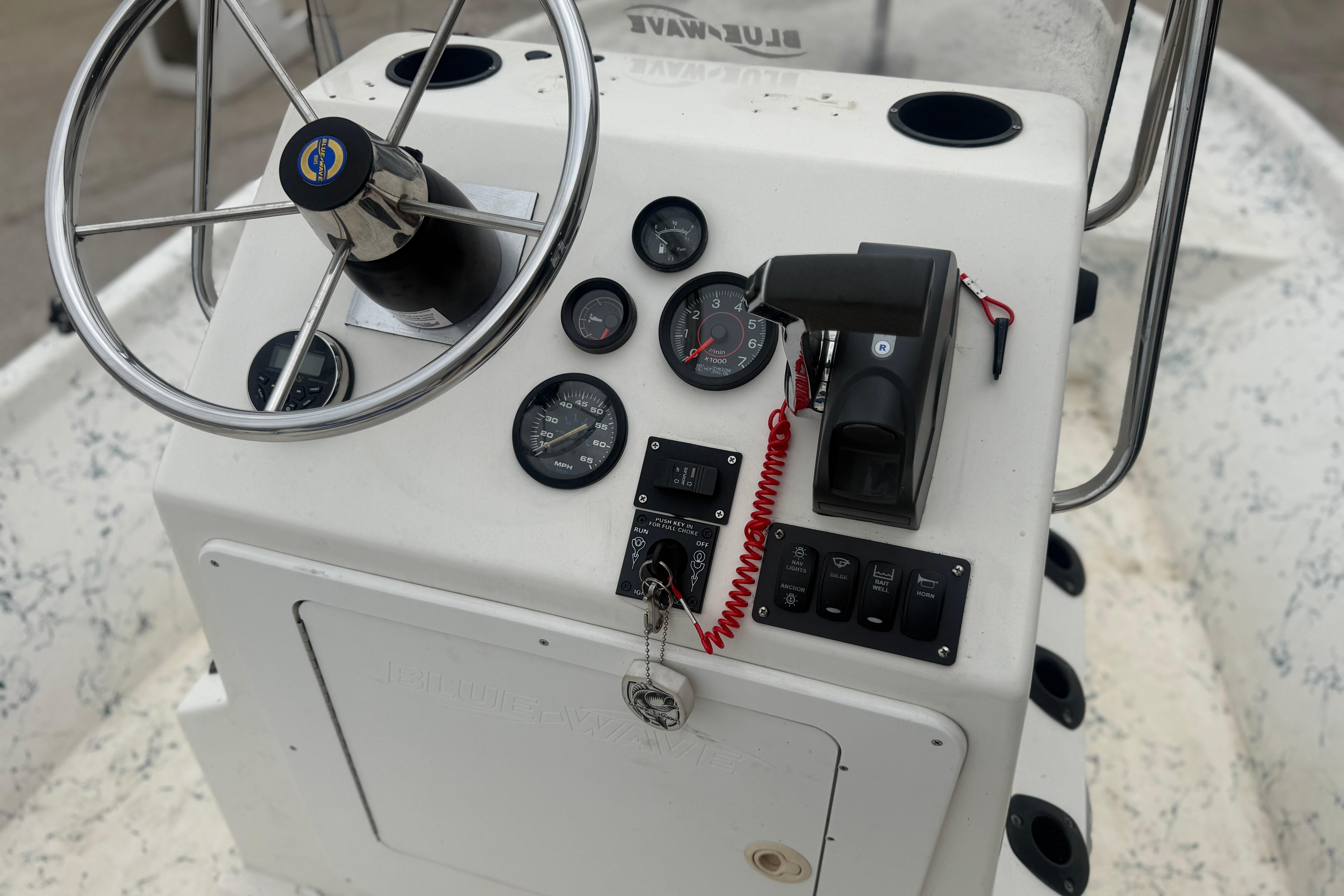 Console of a 2004 Blue Wave 160 V-Bay boat with steering wheel and gauges.