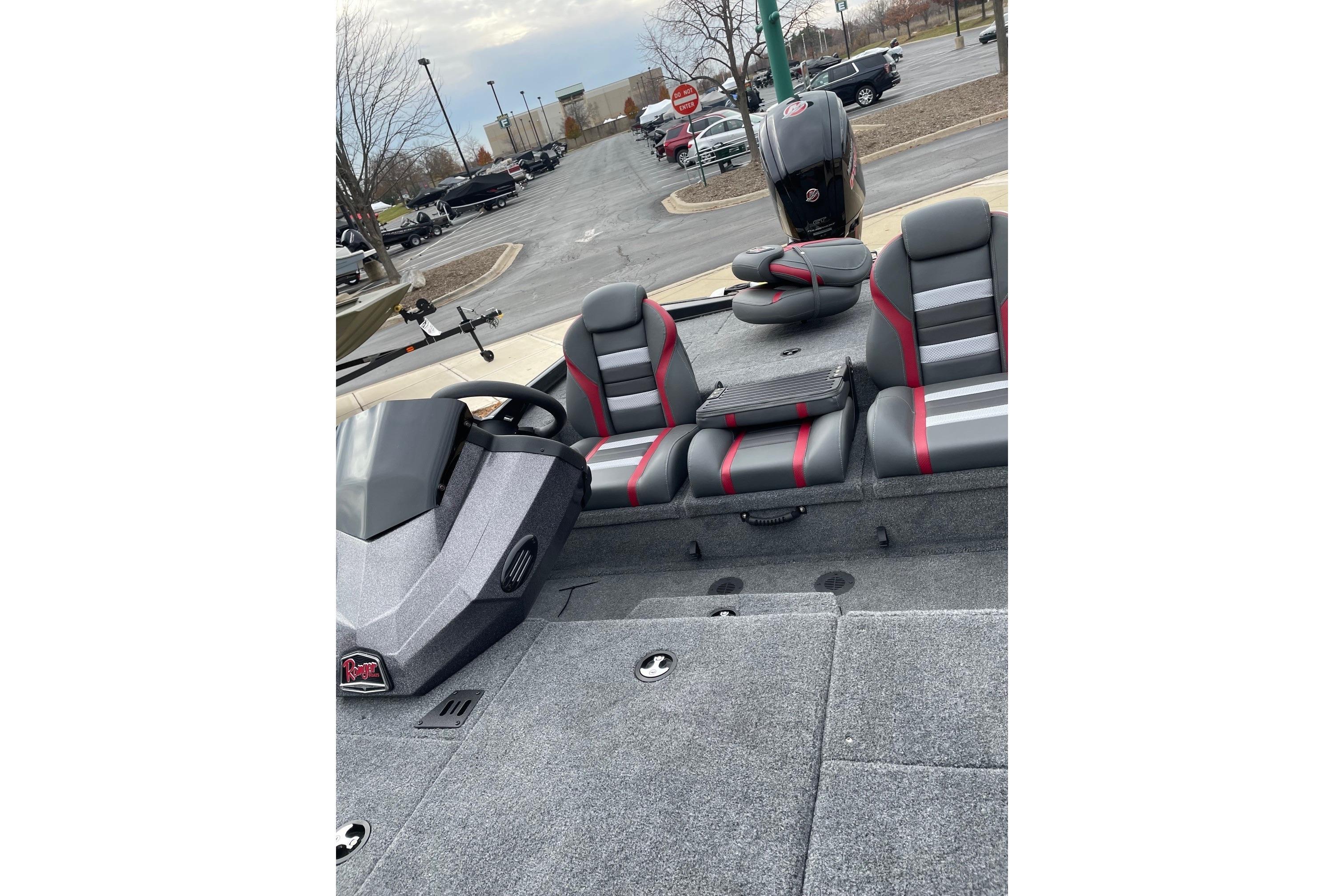 2026 Ranger RT188P boat interior with gray and red seating, parked outdoors.