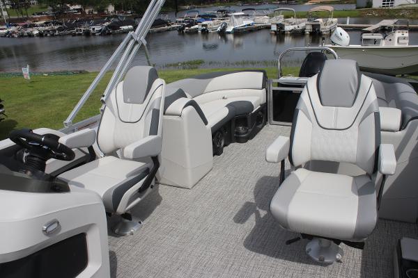 2025 Avalon LSZ Quad Lounger interior with plush seating, steering console, and waterfront view.