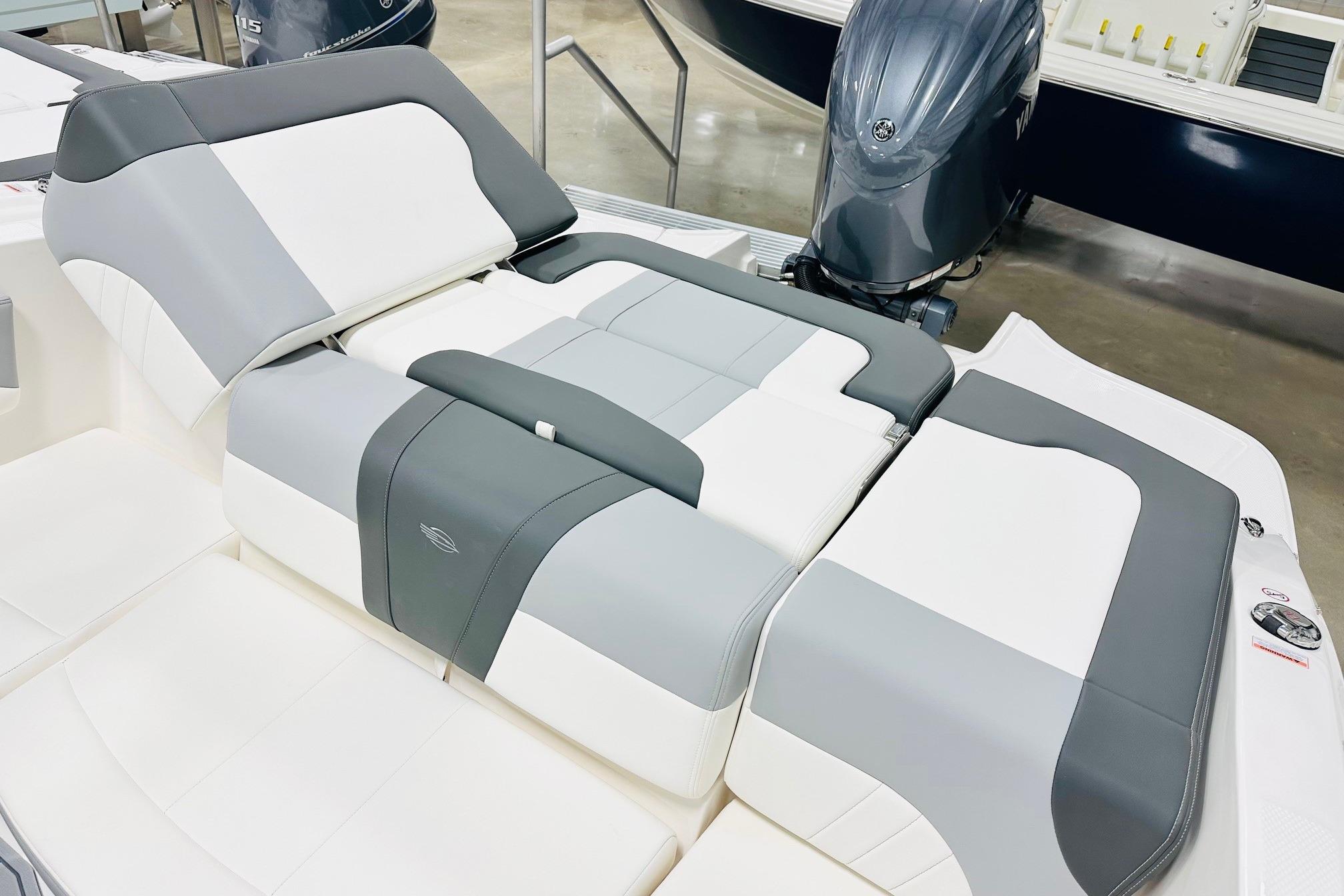 2025 Chaparral 21 SSi OB boat interior with gray and white cushioned seating.