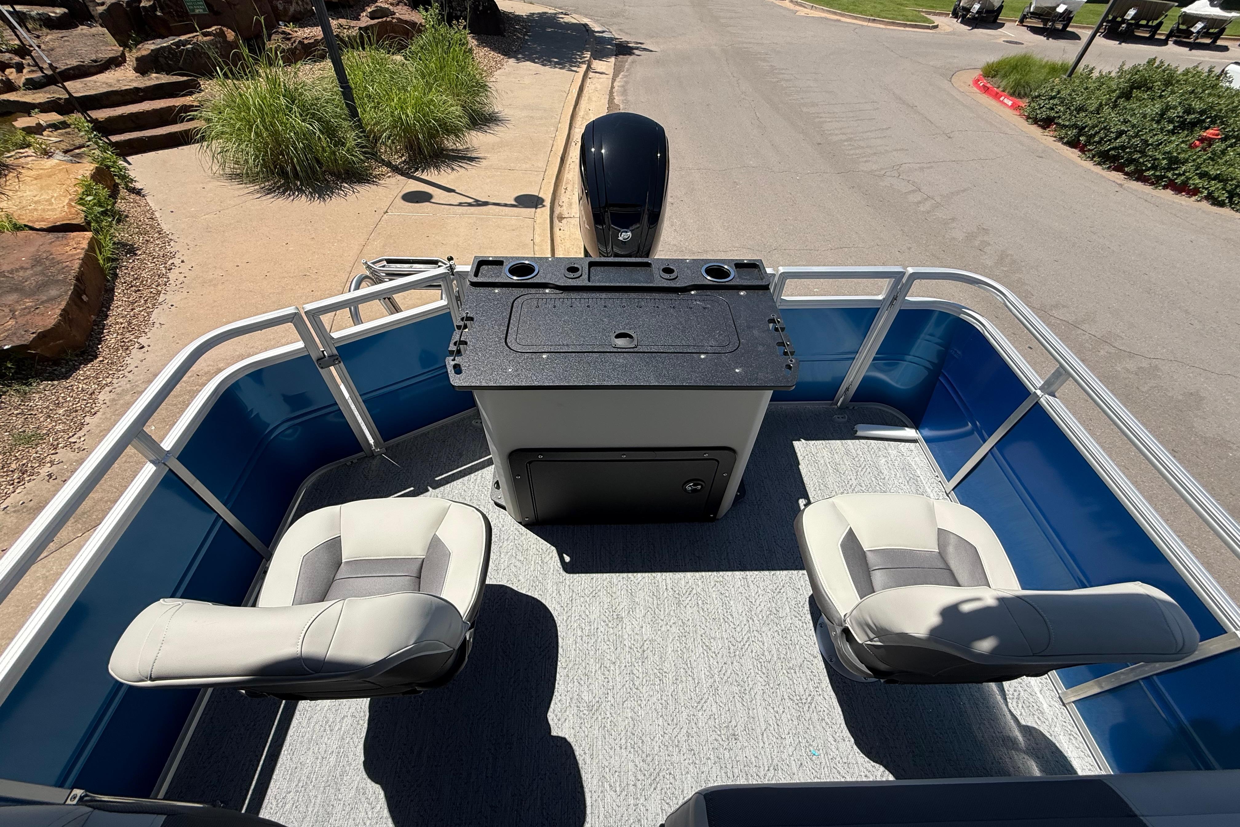 2026 Sun Tracker Fishin' Barge 20 DLX interior with seating and control console.