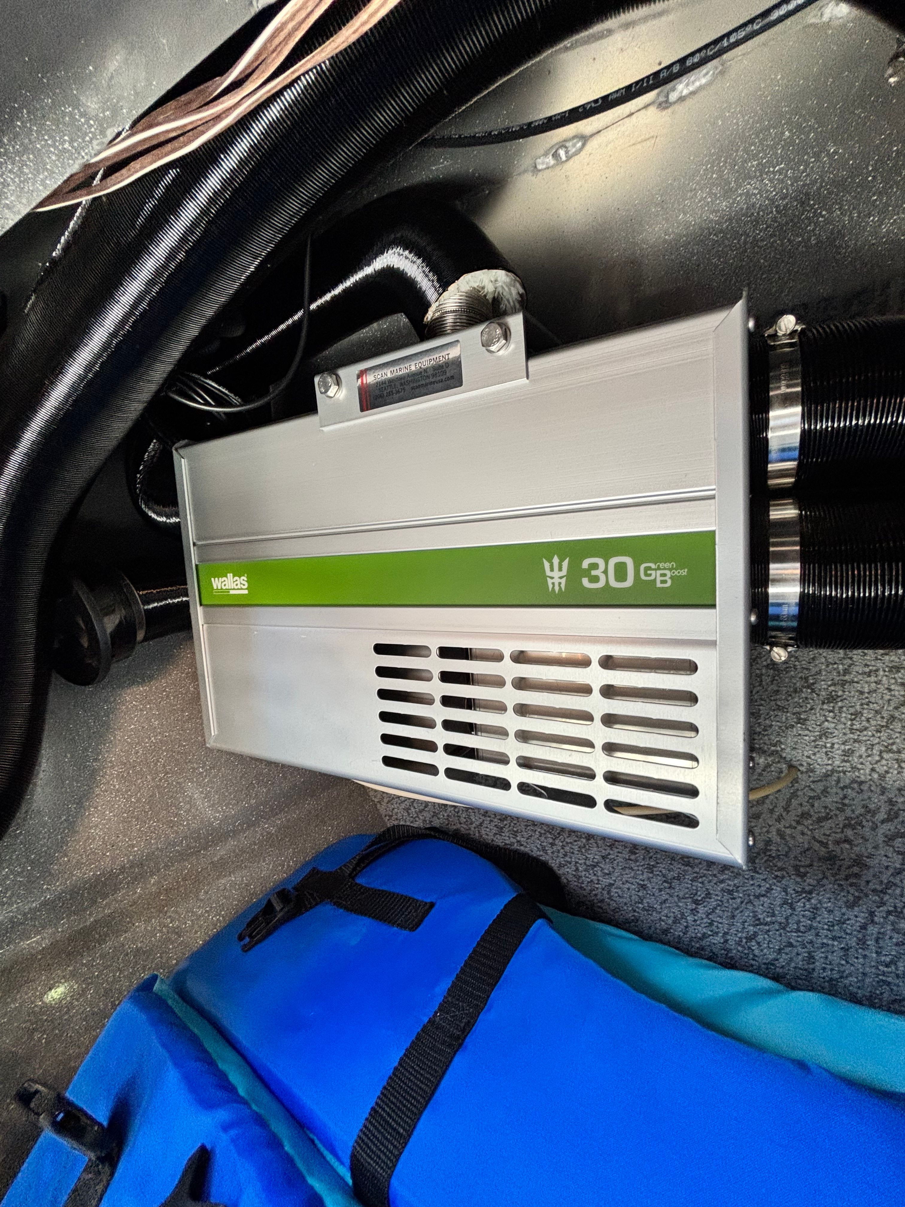 An electrical device with a green stripe and "30 GB" label is installed in a boat.