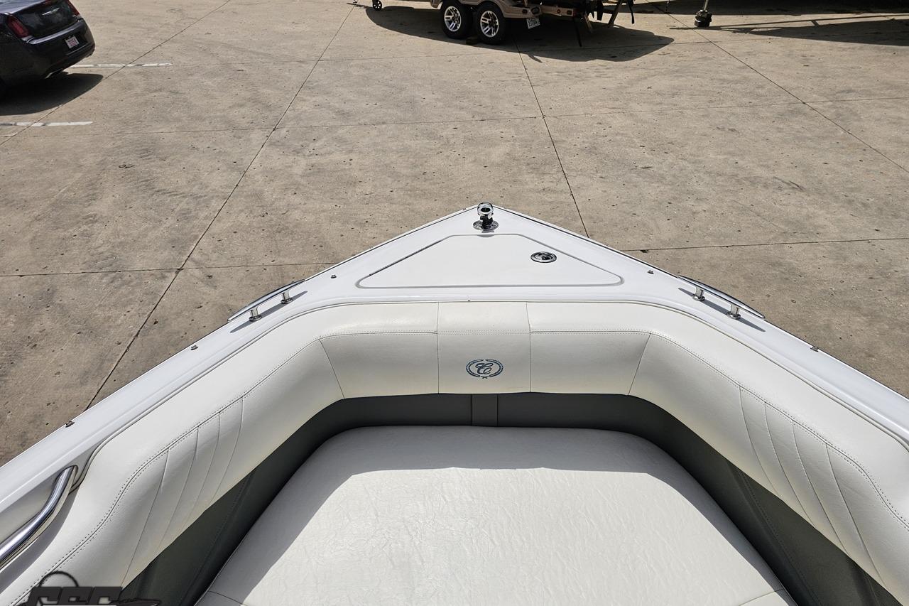 Bow seating area of a 2010 Cobalt 232 WSS boat in a parking lot.