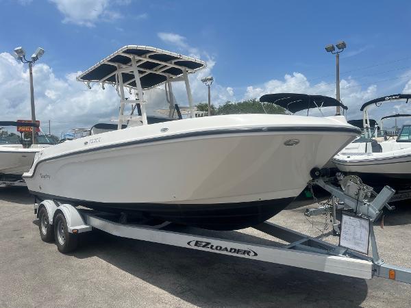2022 Bayliner Trophy T22CC boat on trailer under clear sky.