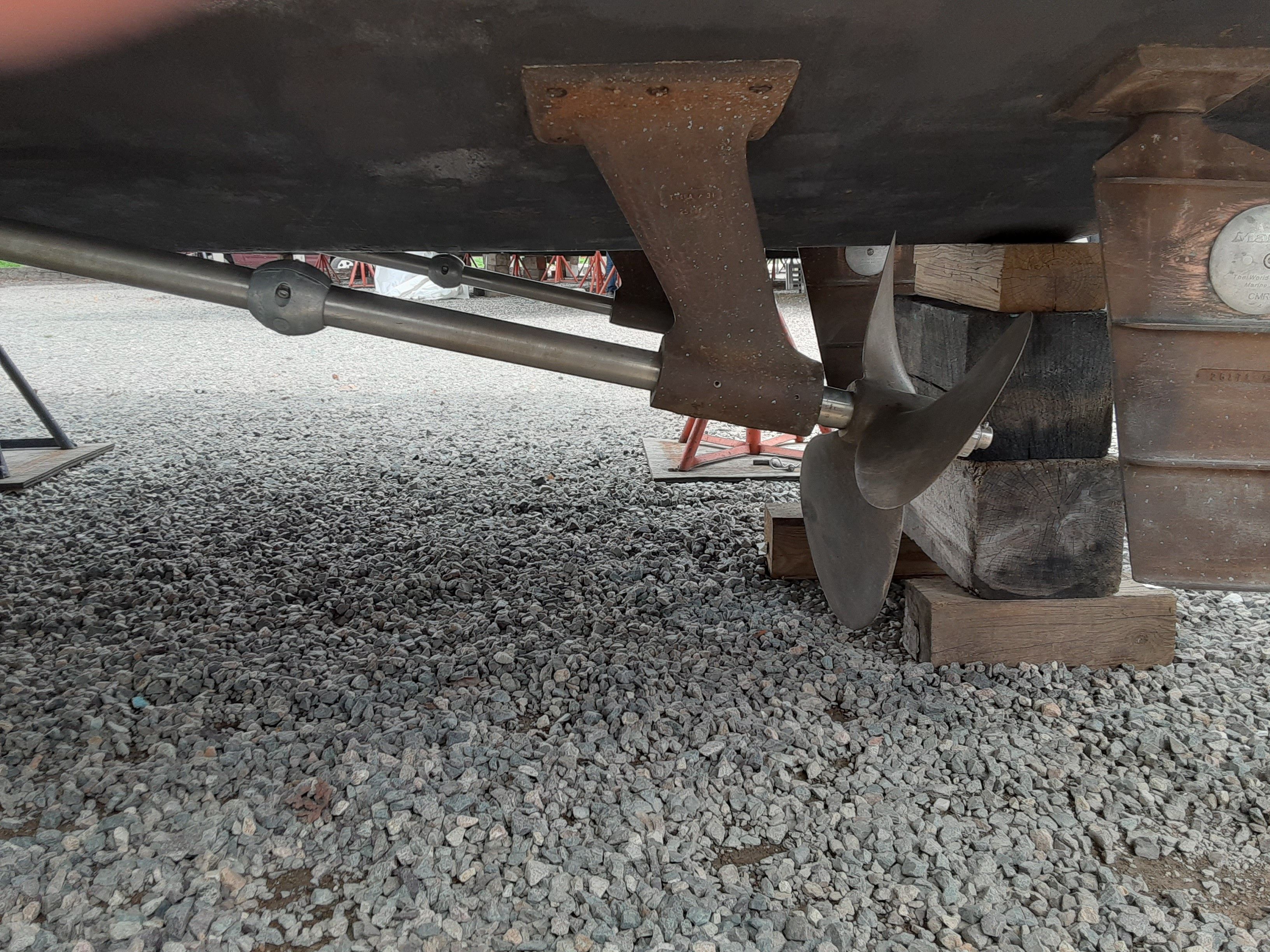 Propeller of a 1985 Tiara Yachts 3100 Open on gravel.