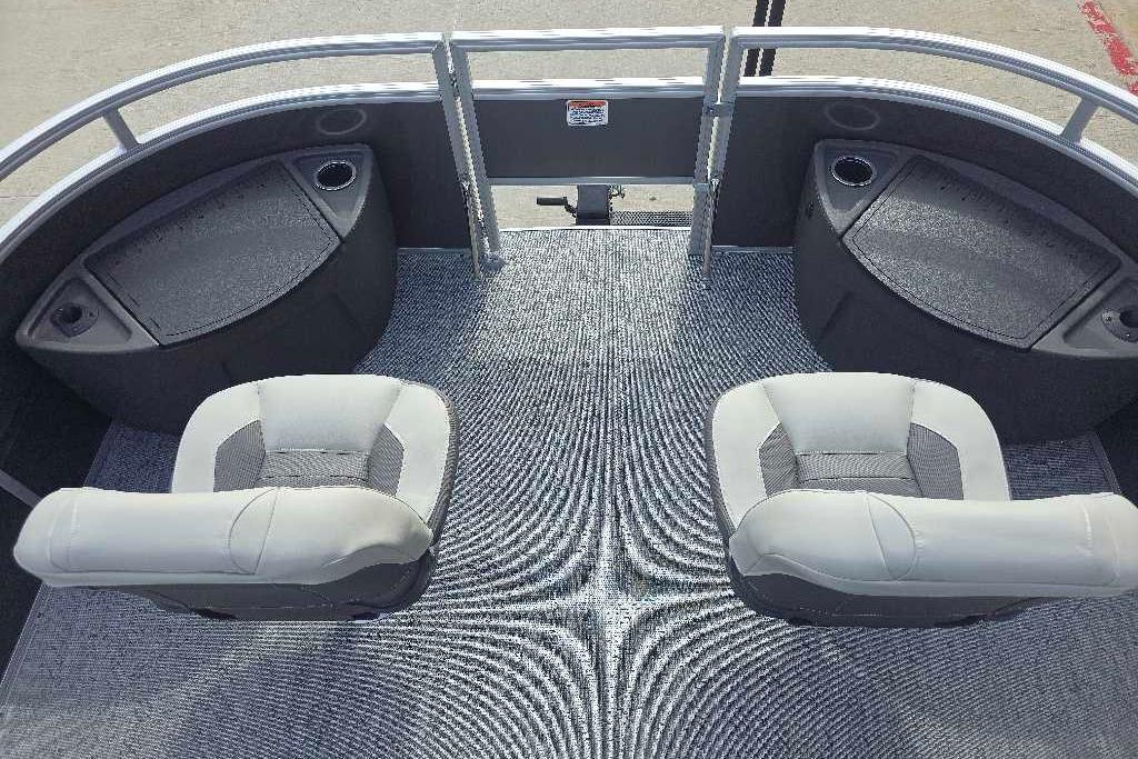 2026 Sun Tracker Fishin' Barge 20 DLX interior with two cushioned seats and storage compartments.