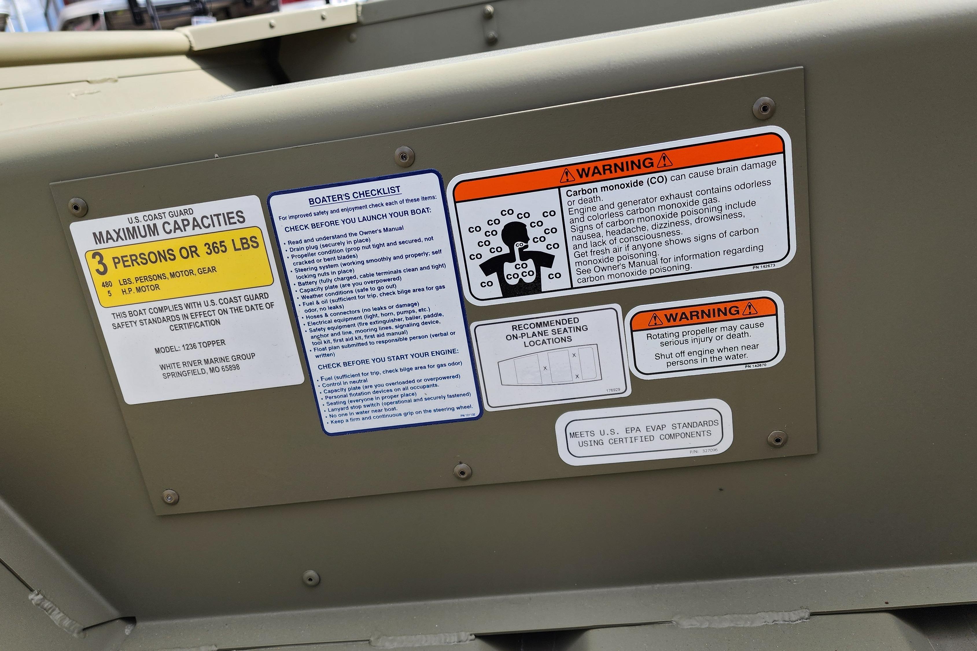 Safety labels on 2026 Tracker Grizzly 12 Jon boat, detailing capacity and warnings.