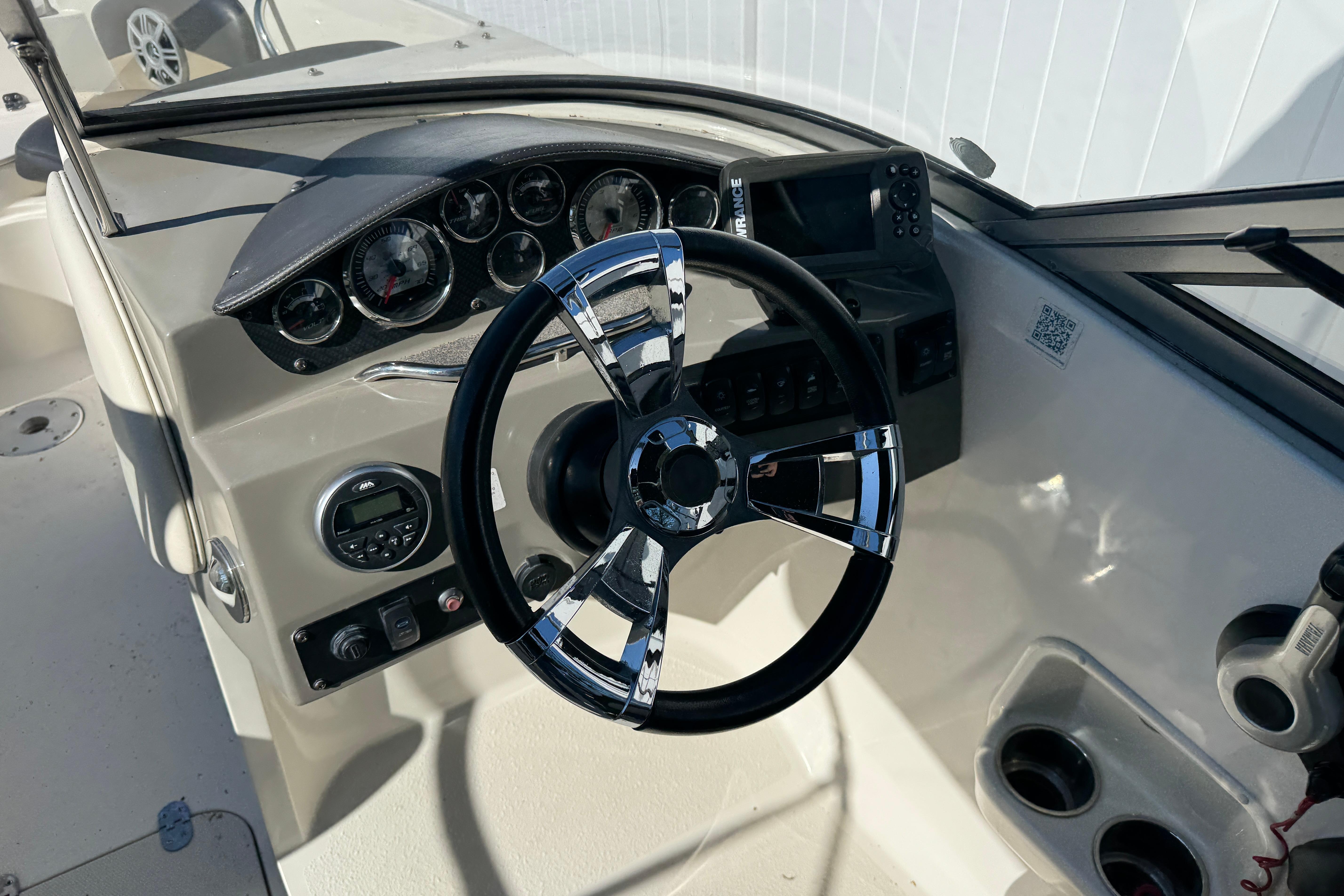2018 Stingray 204 LR boat dashboard with steering wheel and instrument panel.